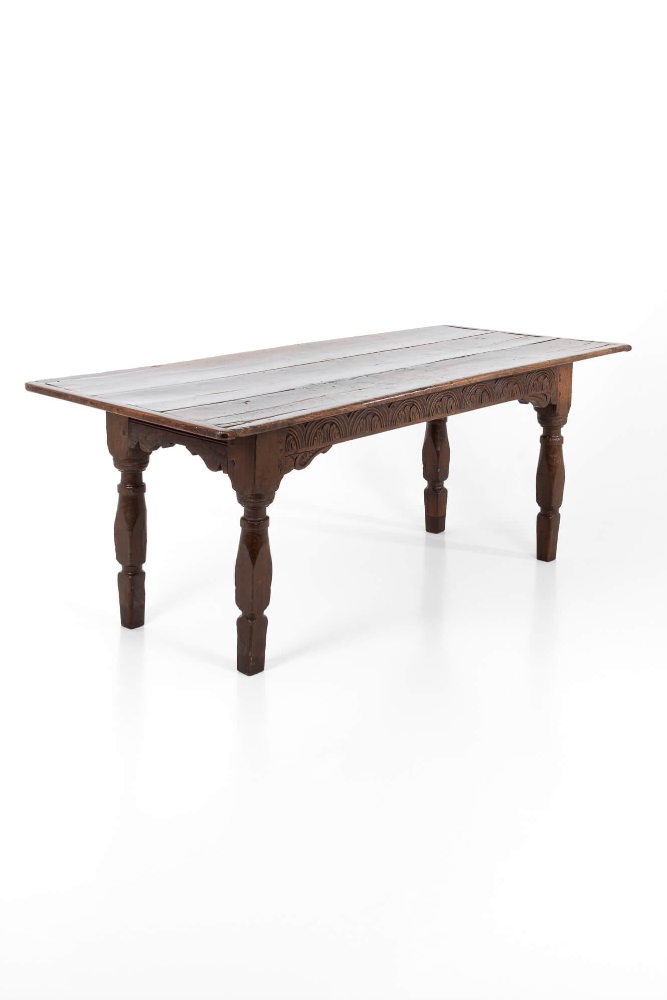A late 17th century refectory table of rectangular form.

Featuring a three-plank top in elm, with oak cleated ends.

Oak base with molded ends and a hand-carved horizontal frieze.

Raised on the four-turned block and baluster supports.

Wonderful