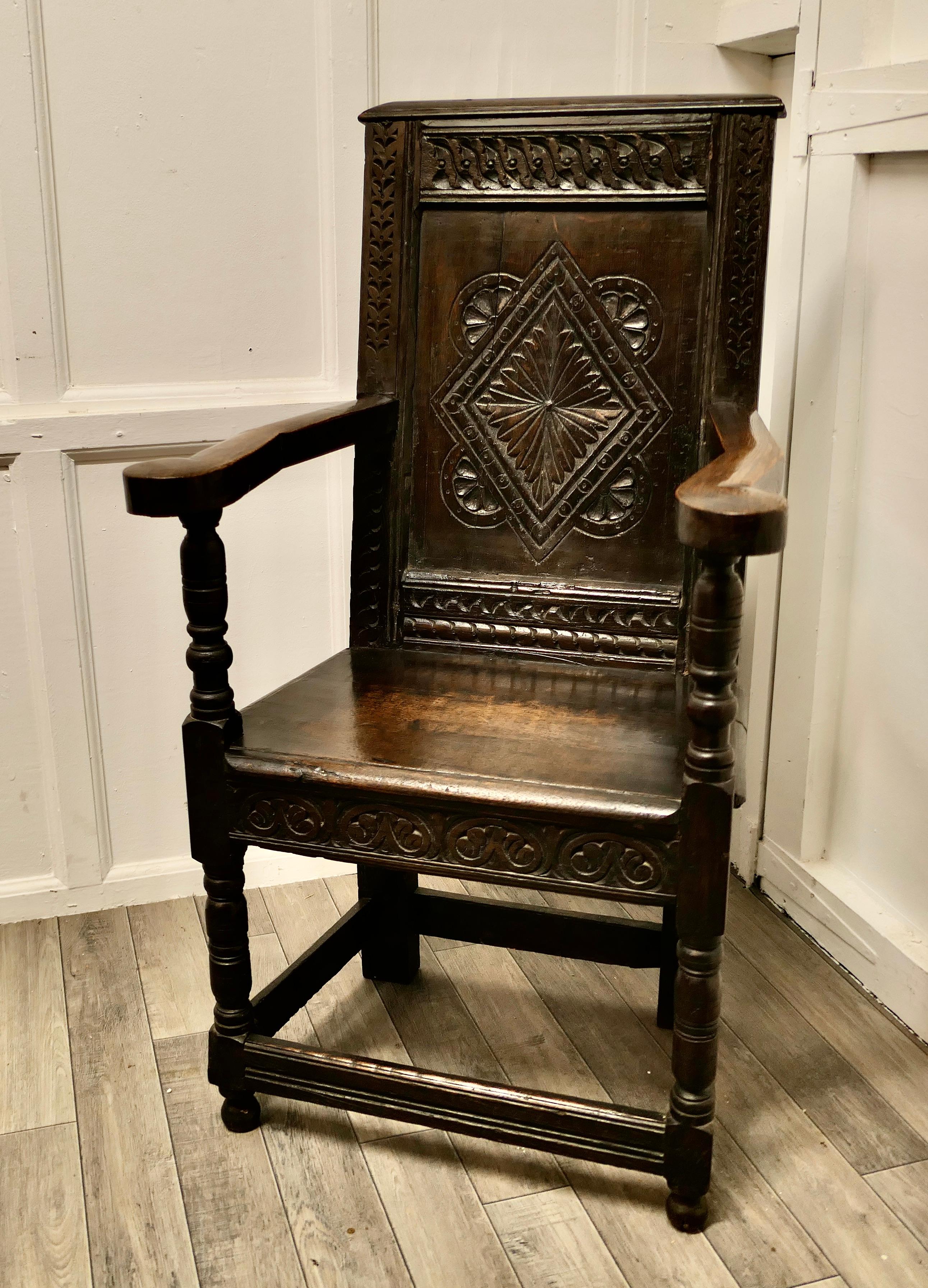 17th Century Oak Wainscot hall chair

This Handsome Chair, has a magnificent patina, the solid plank seat has a little carving to the front border, the back is carved with a large geometric design. The sturdy crook arms are supported with a turned