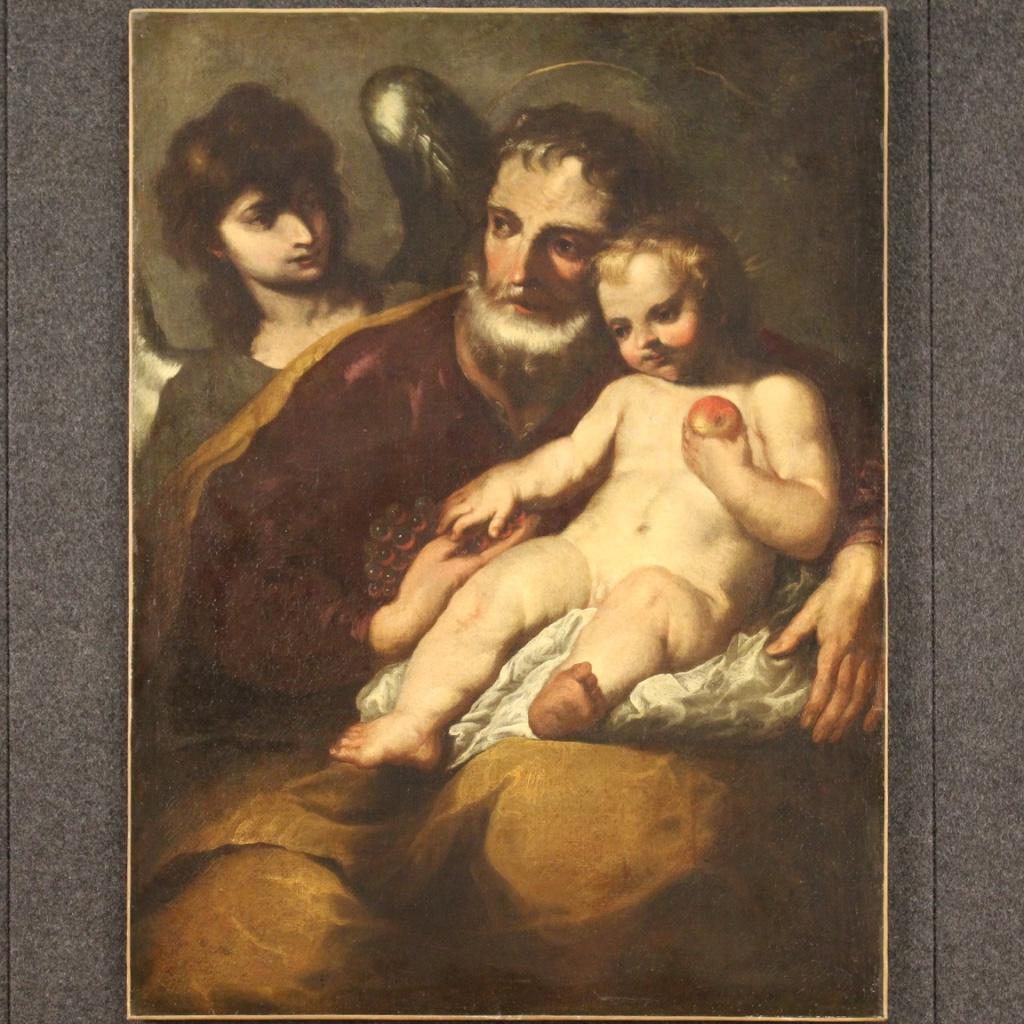 Antique Italian painting from 17th century. Work oil on canvas depicting a religious subject Saint Joseph with child and angel of excellent pictorial quality. Beautifully sized and pleasantly decorated framework, for antique dealers, interior