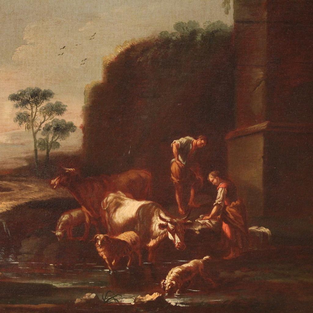 Antique Italian painting from the second half of the 17th century. Oil on canvas artwork depicting a splendid bucolic landscape with figures and grazing animals, of remarkable pictorial quality. At the centre of the composition we find cows, sheep