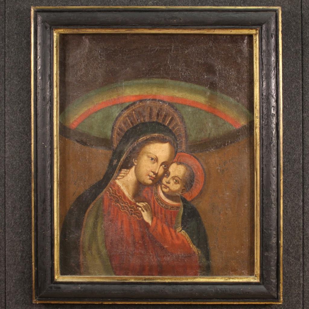 Antique Italian painting from the 17th century. Artwork oil on canvas depicting a religious subject Madonna with child of good pictorial quality. Nice size artwork adorned with a non-coeval carved, ebonized and gilded frame (see photo). Painting