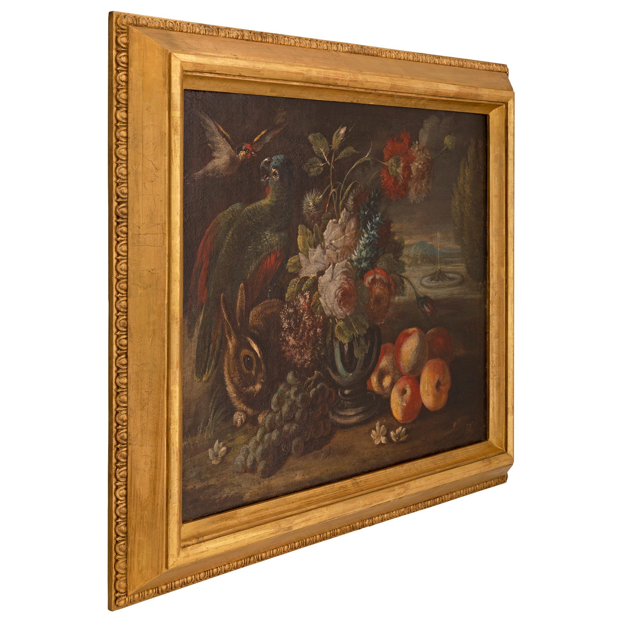An exceptional Continental late 17th century oil on canvas still life painting, in a 19th century giltwood frame. The beautiful painting displays a wonderful array of vivid colors and depicts a charming rabbit, parrot and bird in a beautiful outside