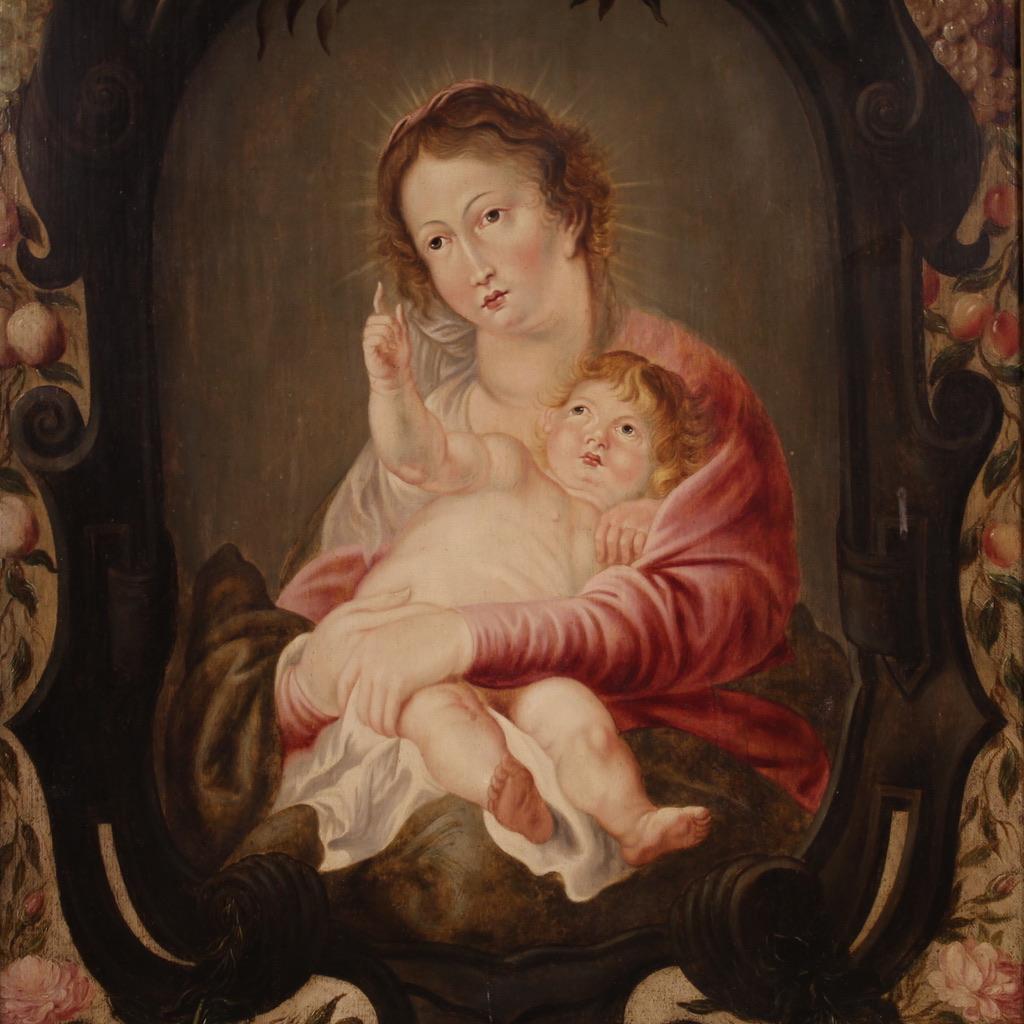 Antique Flemish panel from the first half of the 17th century. Oil painting depicting a splendid Madonna with child inside a niche surrounded by a garland of masterfully painted flowers and fruits. It has a symbol carved on the back of the panel