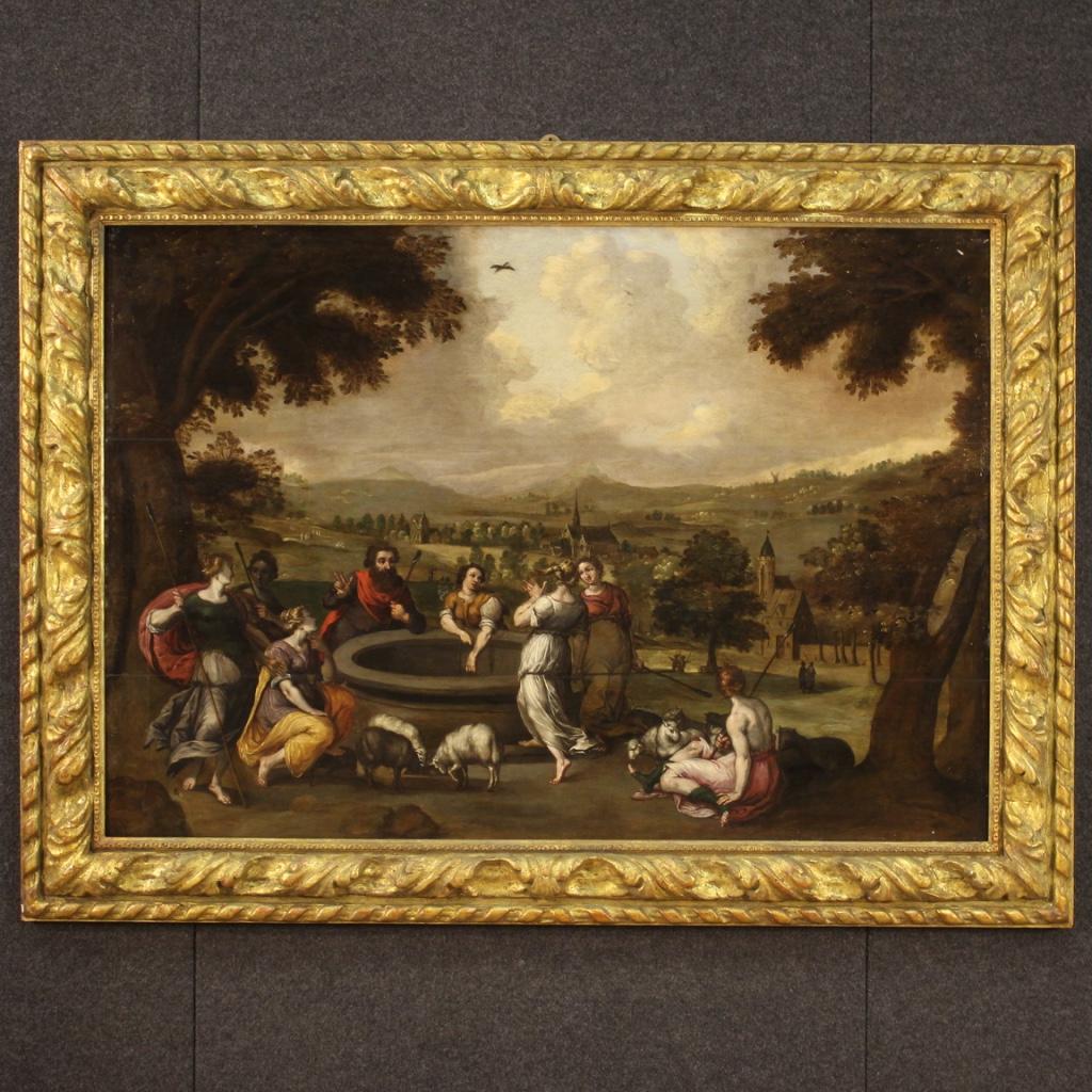 Large 17th century Flemish painting. Oil on panel framework depicting a splendid biblical scene: Moses escaped from Egypt finds rest next to a well where seven sisters arrive. One of them, Zippora, will become his bride. As a future liberator he