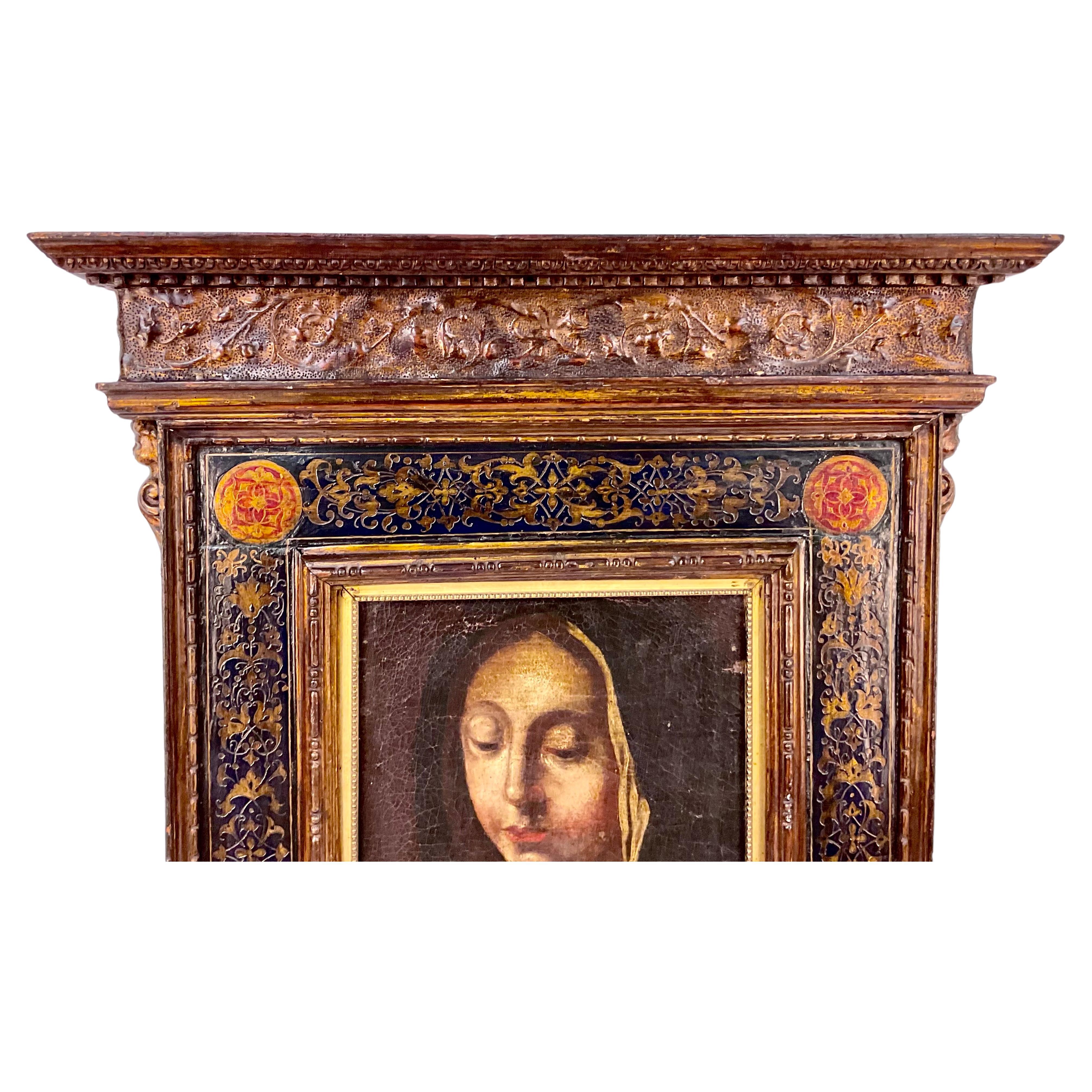 Fine 17th Century Italian School Old Master depiction of the Madonna, oil on canvas. Features navy, red and gold coloring. Navy outer portrait border contains floral motif with red and gold medallions in each corner.  Painting is framed in a very