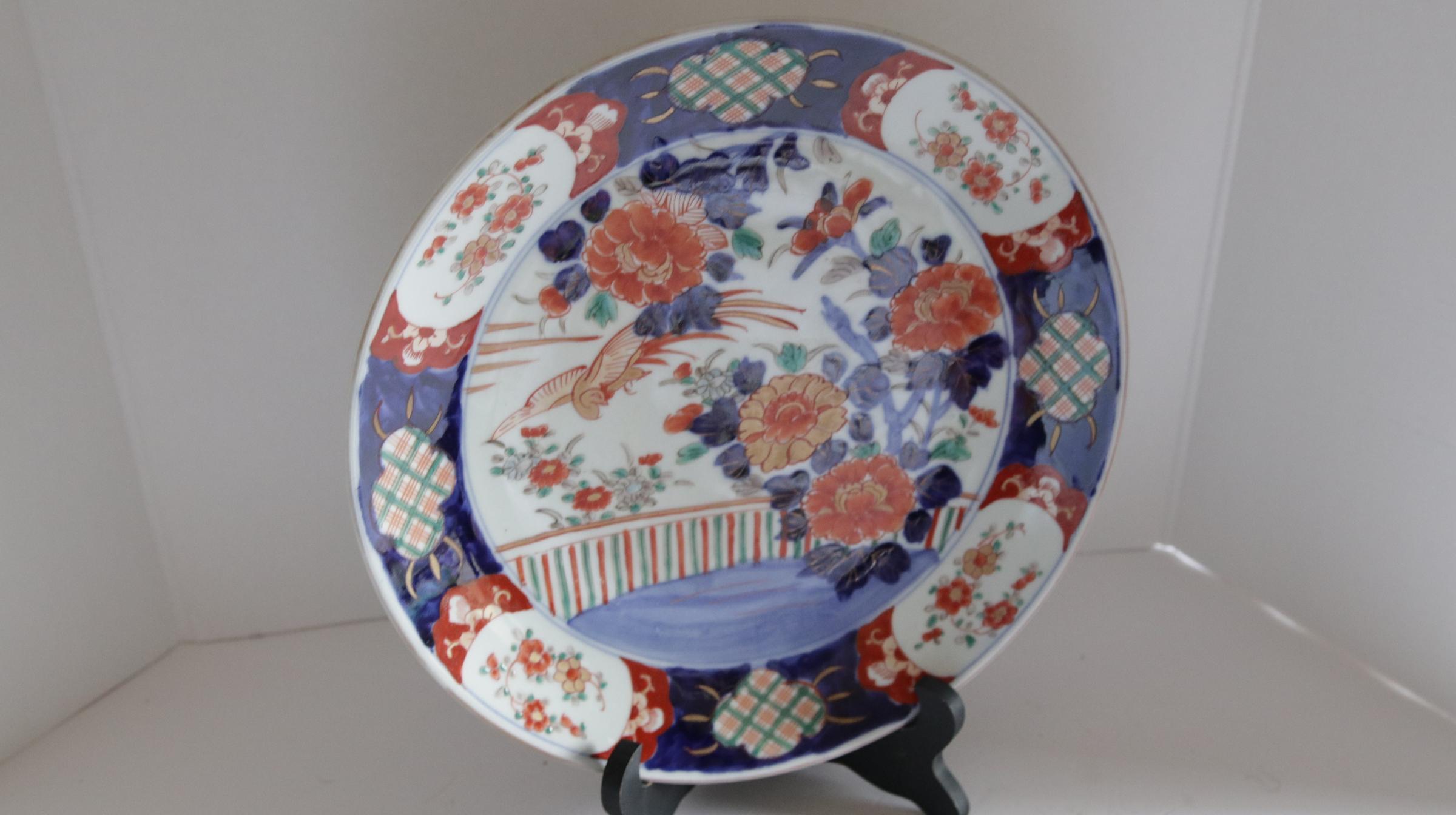 This Japanese Export porcelain charger is singular and speaks for itself in a beautiful palette of soft orange, blue and white. It is remimiscent of Imari, but the appraisers say it is from a 17th or 18th century kiln in Arita Japan. The colors are