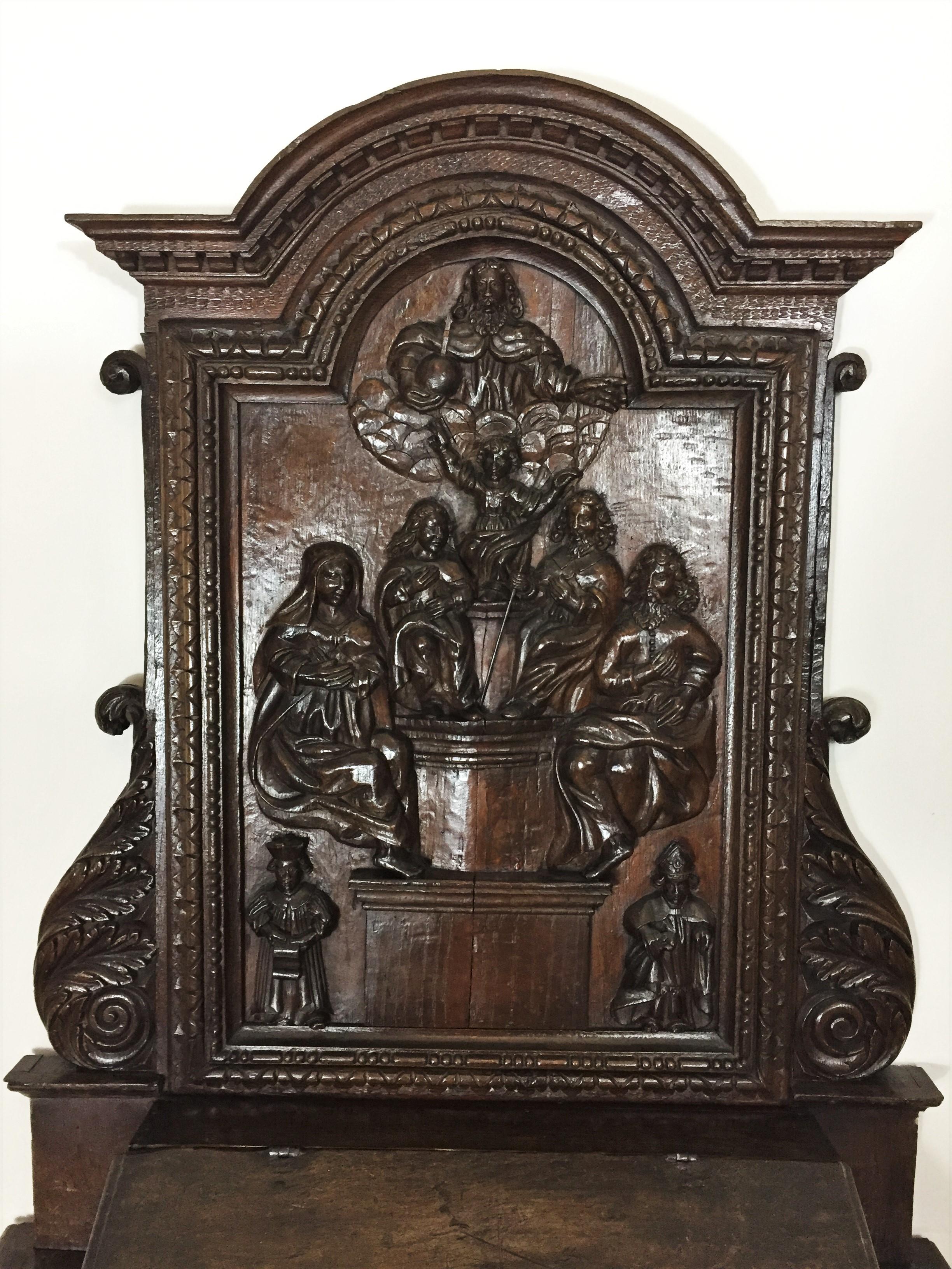 17th century oratory in chestnut with a Representation of the Holy Family Sacristy furniture in oak period Louis XIII with a panel hand carved representing child Jesus in majesty overhung by God the father carrying the orb, surrounded by St.