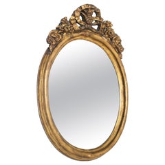 Miroir baroque ovale en bois doré et feuille d'or signé Barris Roma, 18ème siècle