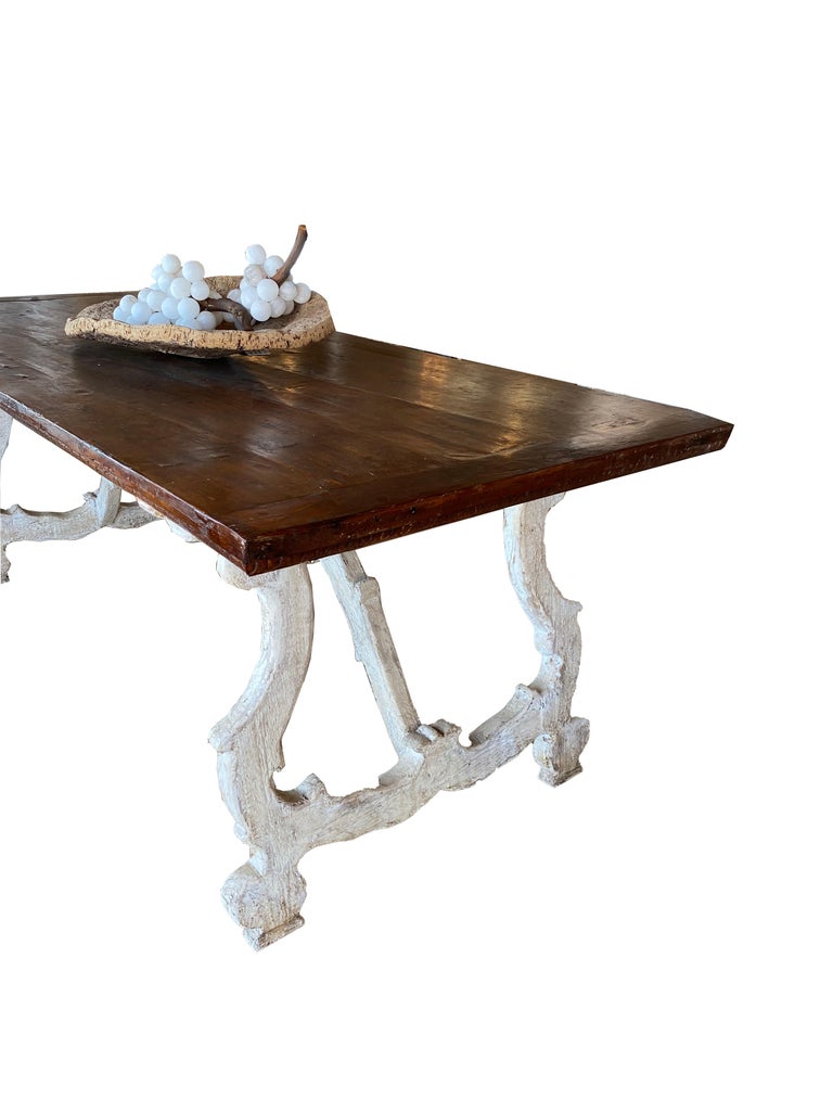 Fabulous 17th century Italian trestle dining table with and 18th century walnut top. The legs have original finish. The top is thick walnut planking with wonderful hand hewn qualities and an egg and dart detail on the apron. This table would make a