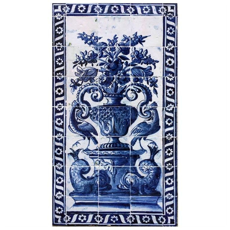 Extraordinary 17th century  with a strong blue on white decoration, representing a flower vase with birds and dolphins in each side.

Tiles panels can be  wooden frame as a painting or embbeded directly on to the wall. Usually displayed in the