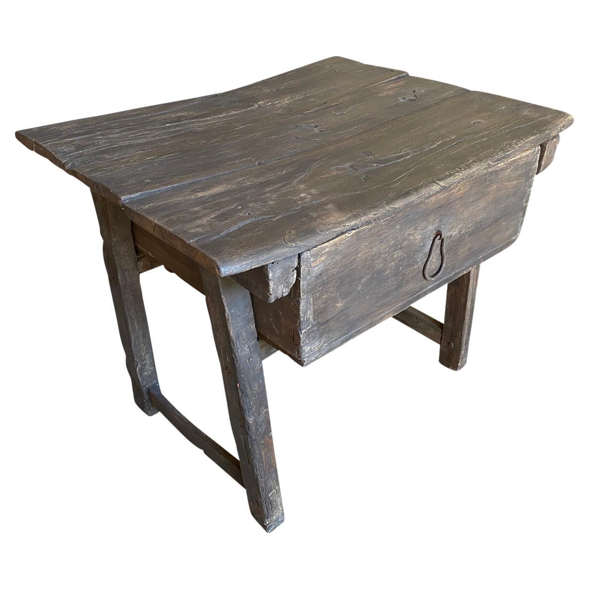 A very charming and rustic Side Table from Portugal. Soundly constructed from olive, chestnut and poplar with a single drawer. Handsome patina.