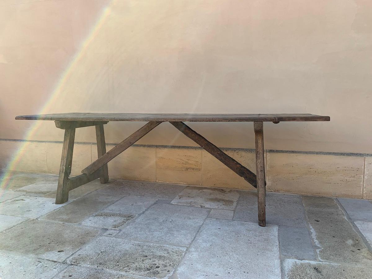 Great 17th century trestle table from the Pyrinee region. Also called Mountain or Montagnard table this piece is preserved in its weather greyed patina as found. The top is maid from 3 chestnut boards fixed to the trestle supports with hand forged