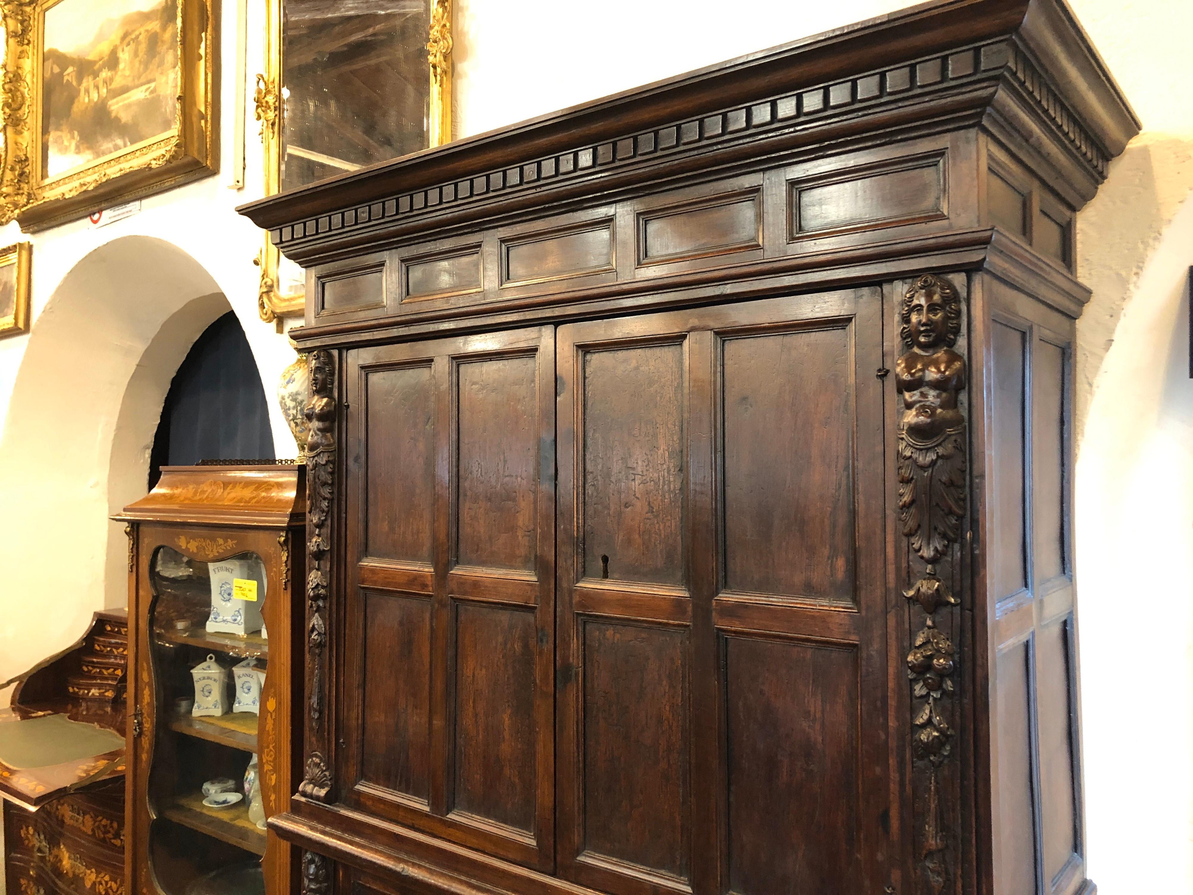 Double body Italian credenzas, Renaissance period, circa 1580 , Tuscany area, walnut wood, finely carved on the uprights with figures of men and women, completely original and in excellent state of preservation. Only on the rear lining was a piece