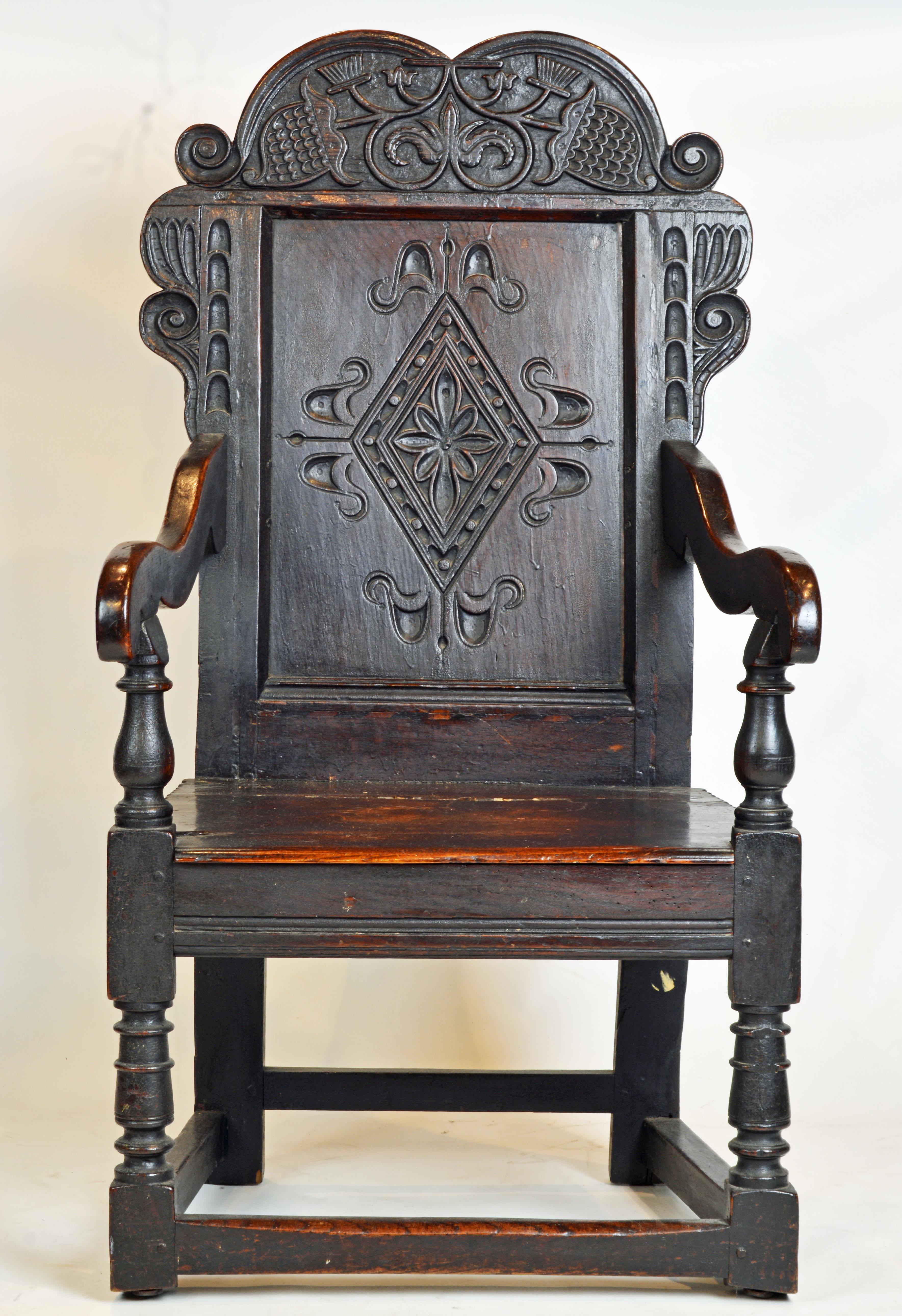 The style of this Elizabethan joined oak chair made in the mid-1600s is a descendant of the Tudor era Wainscot chairs only now without the boxed storage area beneath the seat. The front arm supports are baluster turned and protrude through the seat