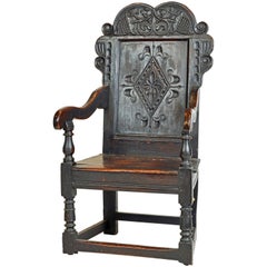 chaise élisabéthaine en chêne jointé du 17ème siècle richement sculptée de style Wainscot