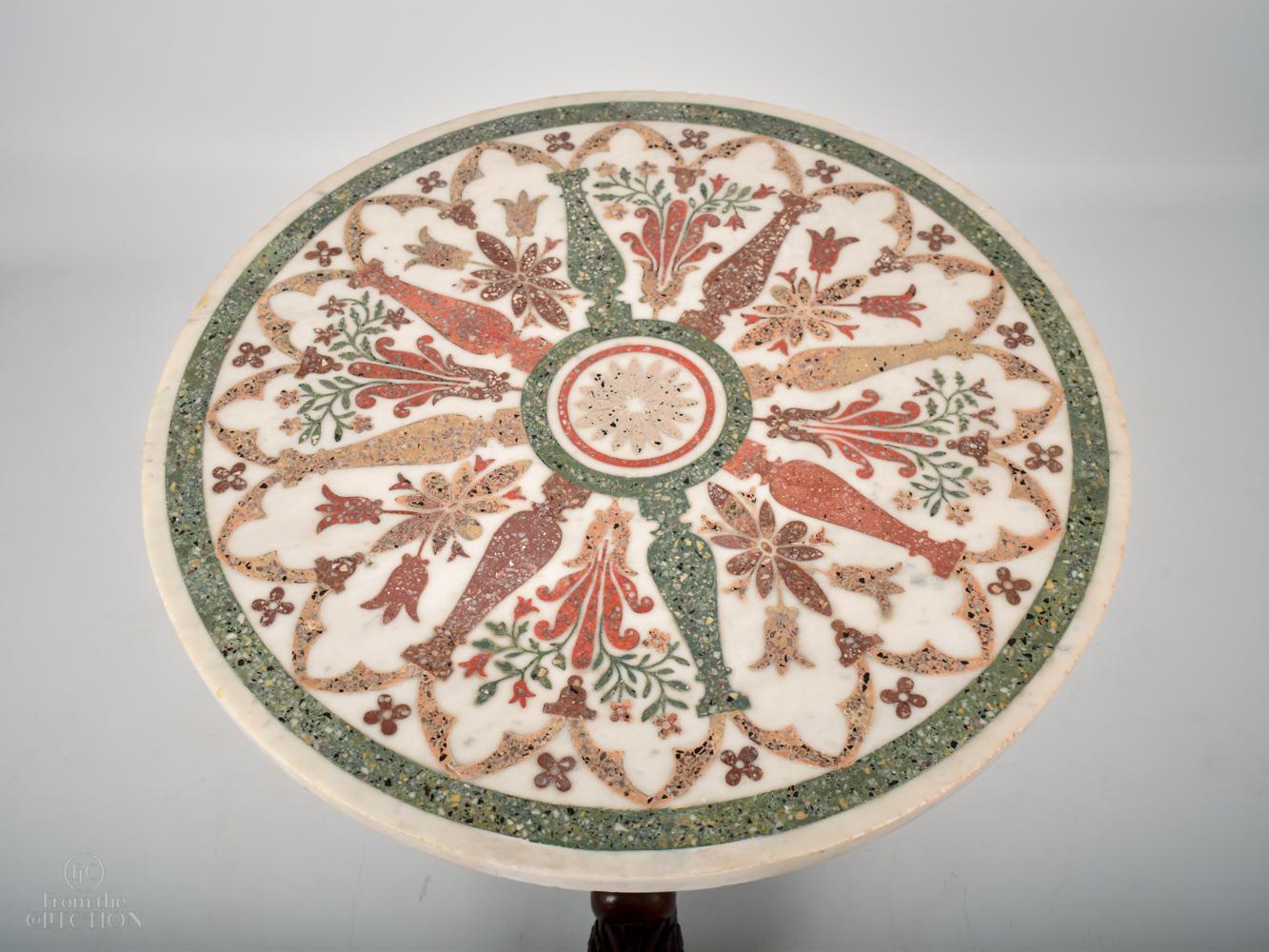 A beautiful Scagliola table top circular table inlaid with various exotic agates and marbles detailed in a roman style design. The 17th century top sits on a later William IV plinth of mahogany with three splayed legs on claw feet. An extremely fine