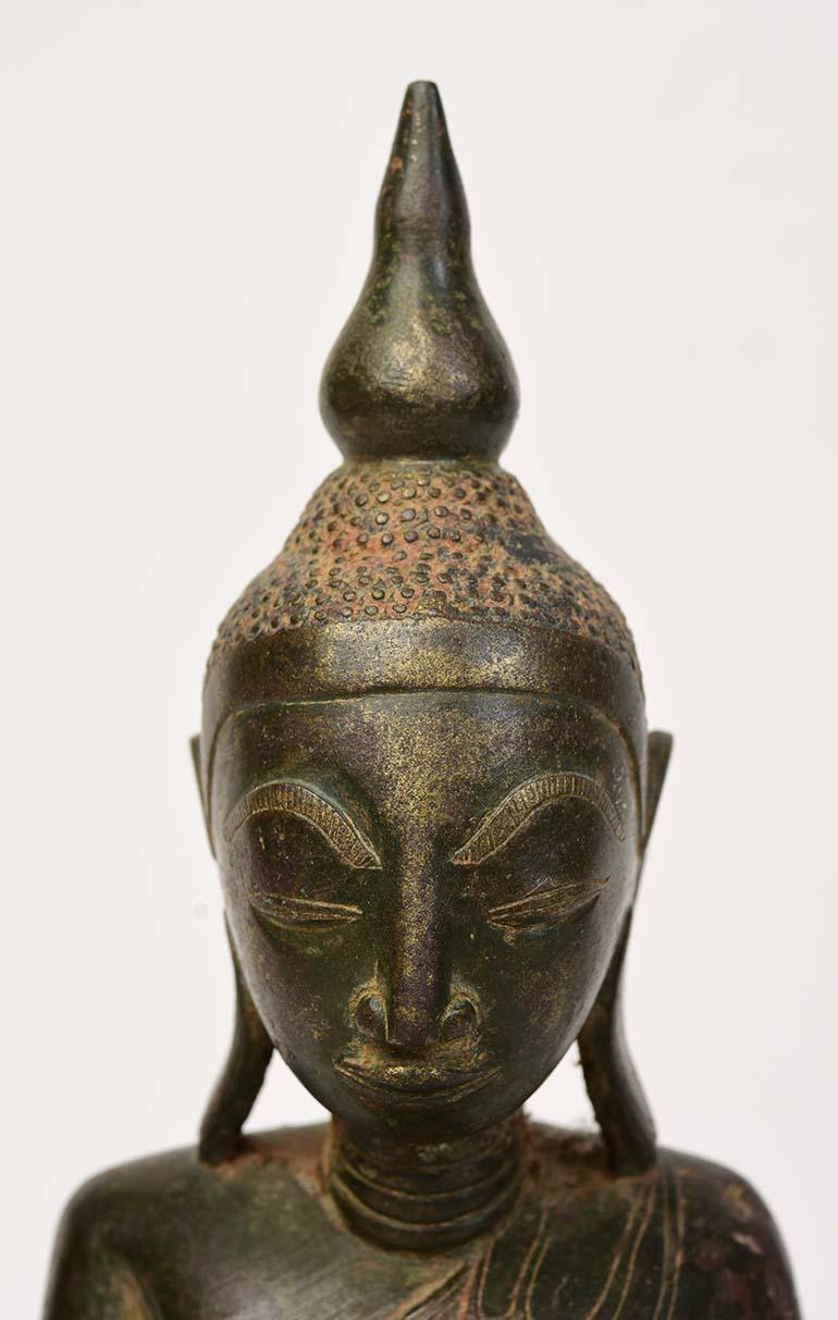 Burmese bronze Buddha sitting in Mara Vijaya (calling the earth to witness) posture on a base.

Age: Burma, Shan Period, 17th Century
Size: Height 30.3 C.M. / Width 19 C.M.
Condition: Nice condition overall.

100% satisfaction and authenticity