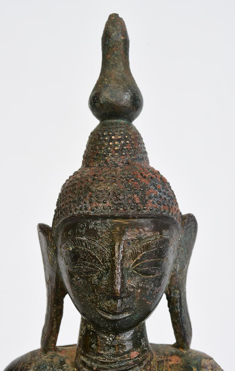 Burmese bronze Buddha sitting in Mara Vijaya (calling the earth to witness) posture on a base.

Age: Burma, Shan Period, 17th Century
Size: Height 25.8 C.M. / Width 12.1 C.M. / Thickness 6.2 C.M.
Condition: Nice condition overall (some expected