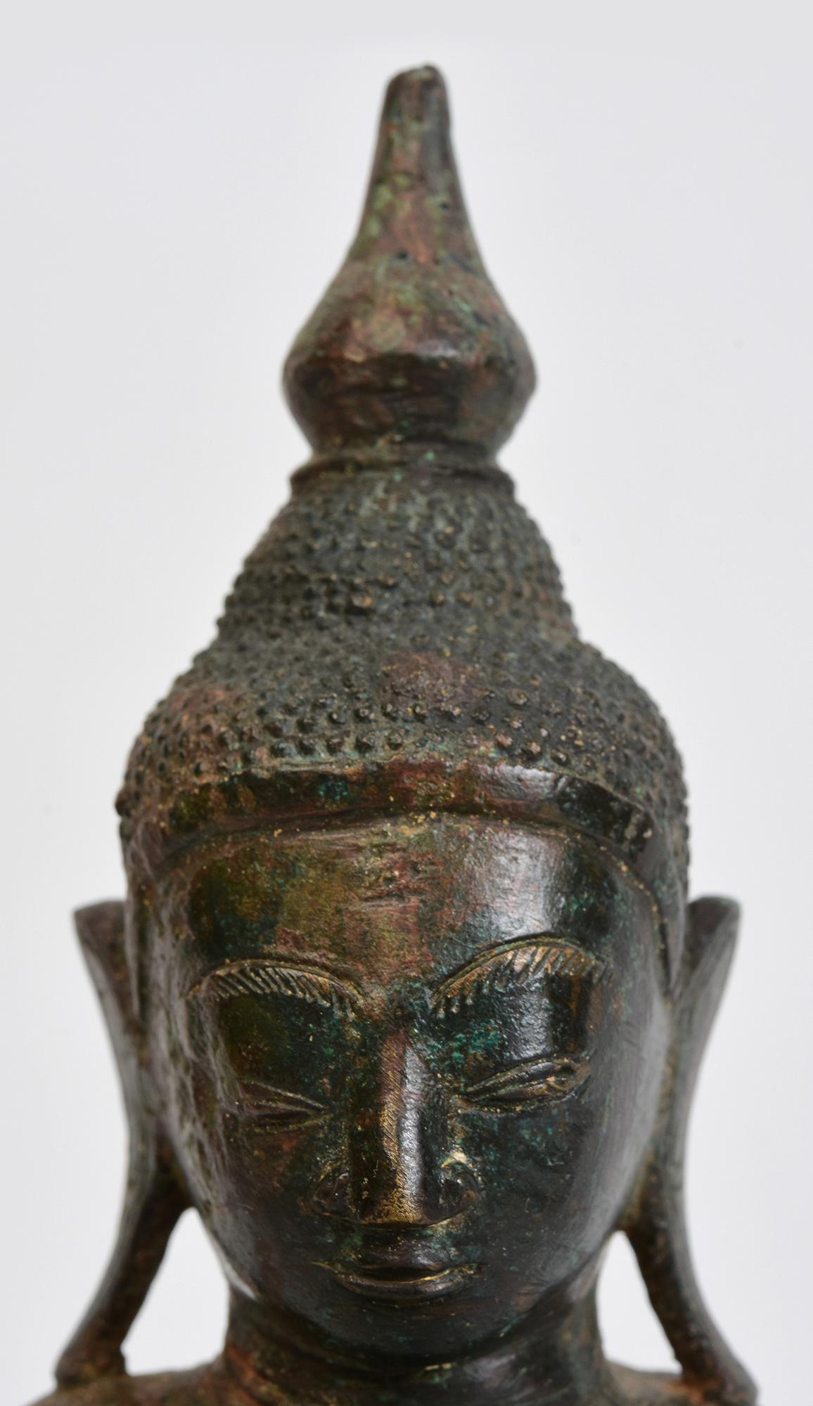 Antique Burmese bronze Buddha sitting in Mara Vijaya (calling the earth to witness) posture on a base.

Age: Burma, Shan Period, 17th Century
Size: Height 26.2 C.M. / Width 14.5 C.M. / Depth 8.2 C.M.
Condition: Nice condition overall (some expected