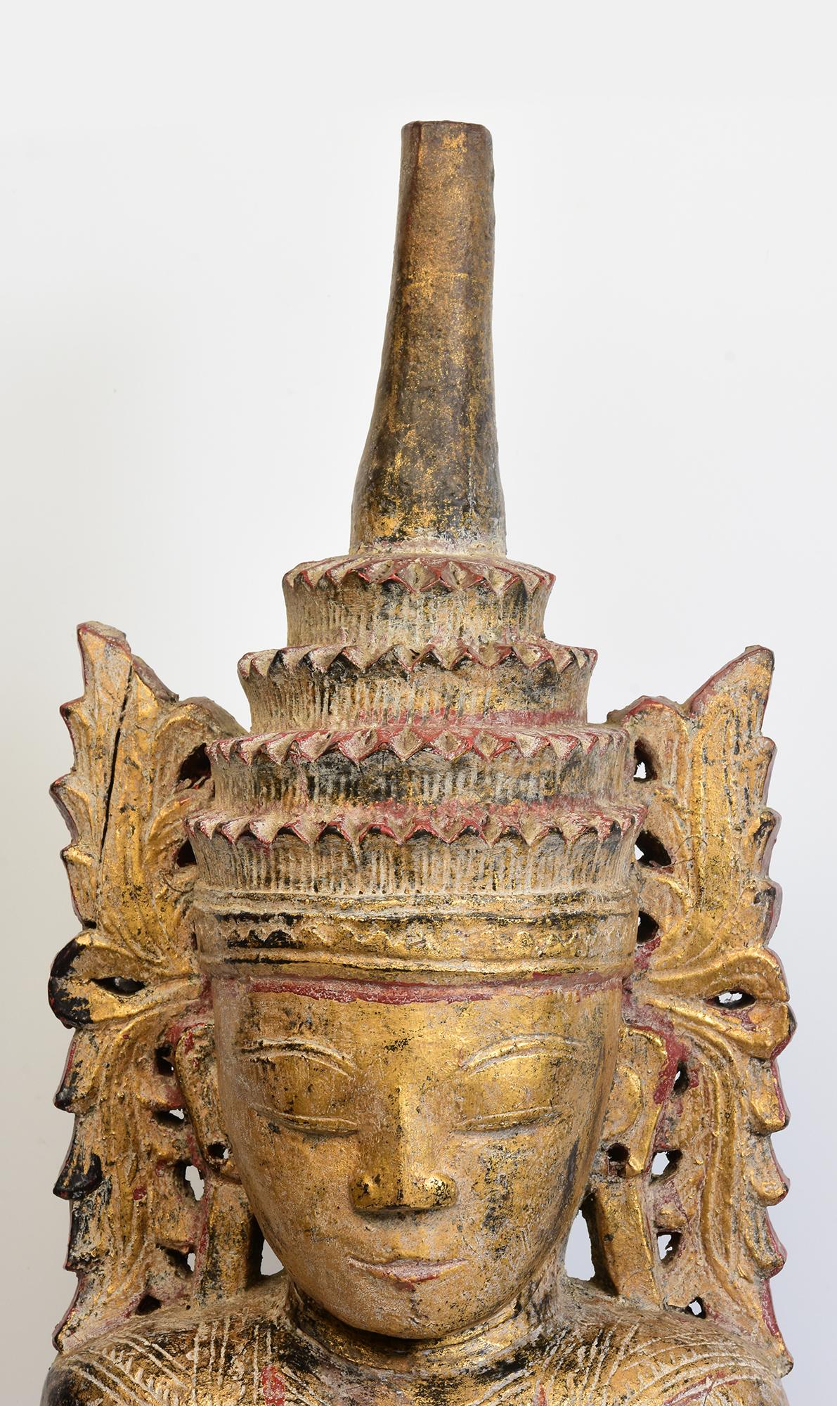 Antique Burmese wooden seated crowned Buddha, or sometimes known as 'King Buddha', wearing diadem-crowns and ornaments of kings instead of ordinary monk's robes.

Crowned Buddha represents the Buddha's role as a universal sovereign. 

Age: Burma,