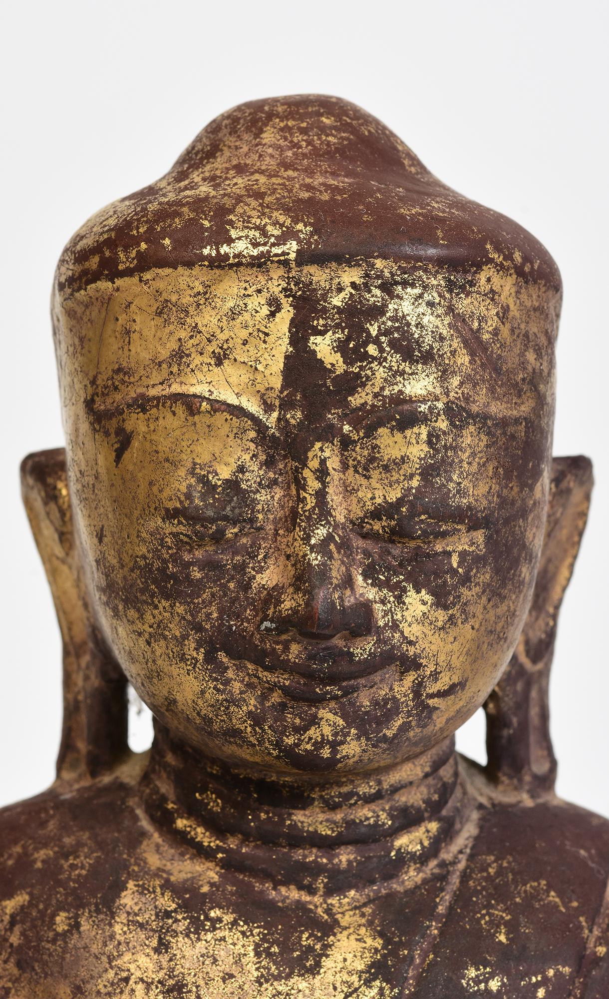 Antique Burmese wooden lotus Buddha sitting in Mara Vijaya (calling the earth to witness) posture on a base.

Age: Burma, Shan Period, 17th Century
Size: Height 33 C.M. / Width 19 C.M.
Condition: Nice condition overall (some expected degradation due