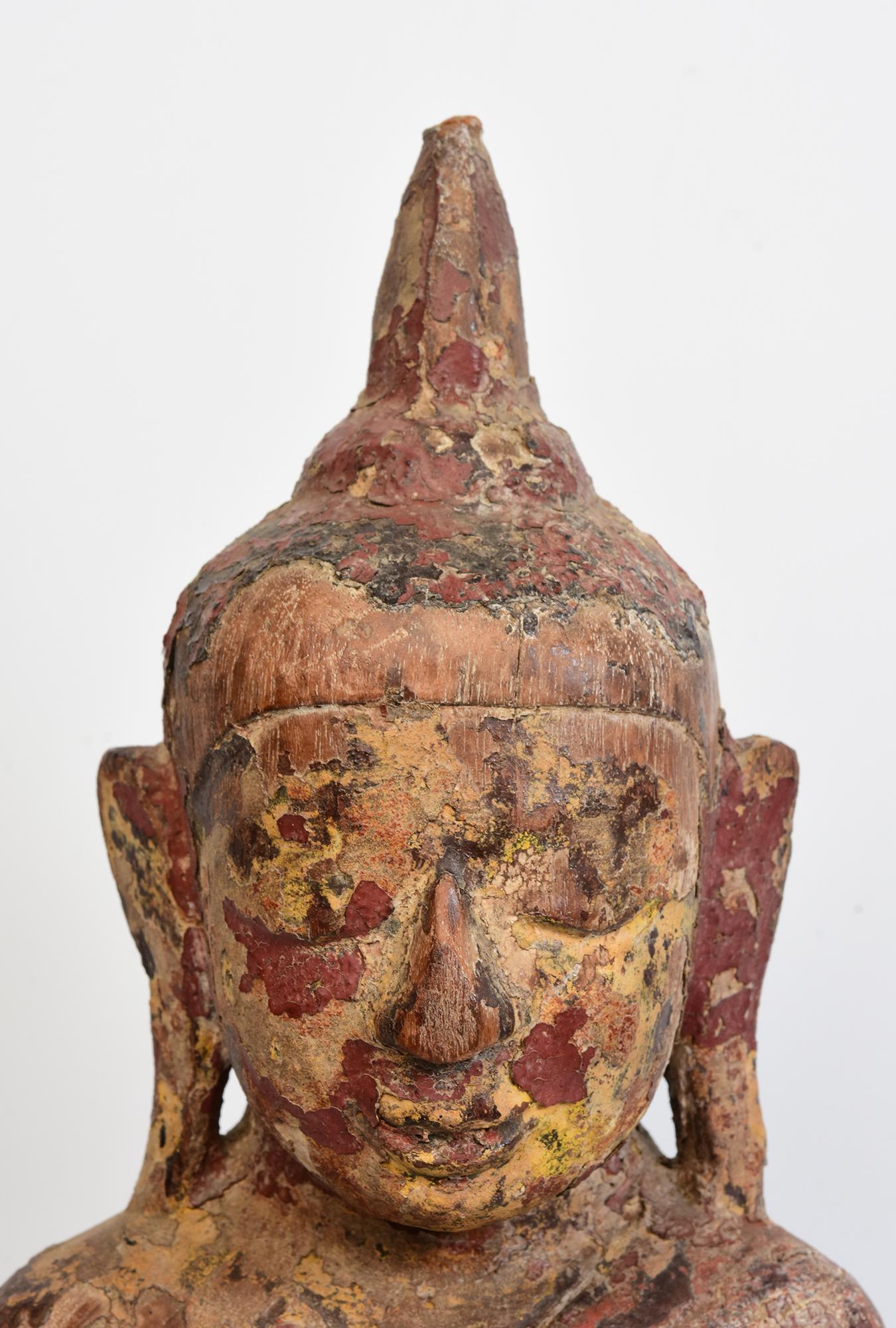 Antique Burmese wooden Buddha sitting in Mara Vijaya (calling the earth to witness) posture on a base.

Age: Burma, Shan Period, 17th Century
Size of Buddha only: Height 48 C.M. / Width 20.7 C.M. / Depth 9 C.M.
Height including stand: 49.5