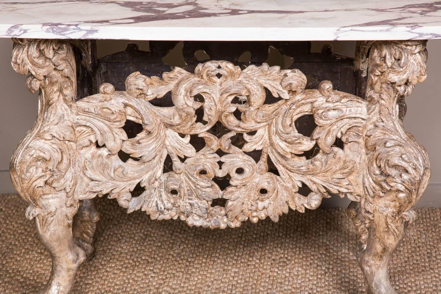 A magnificent Dutch late 17th century silver-gilt console or centre table. On lion paw legs with intricately carved Baroque stretchers panels. The silver gilding beautifully aged and muted. The Brocatello top thickly hewn from a solid and