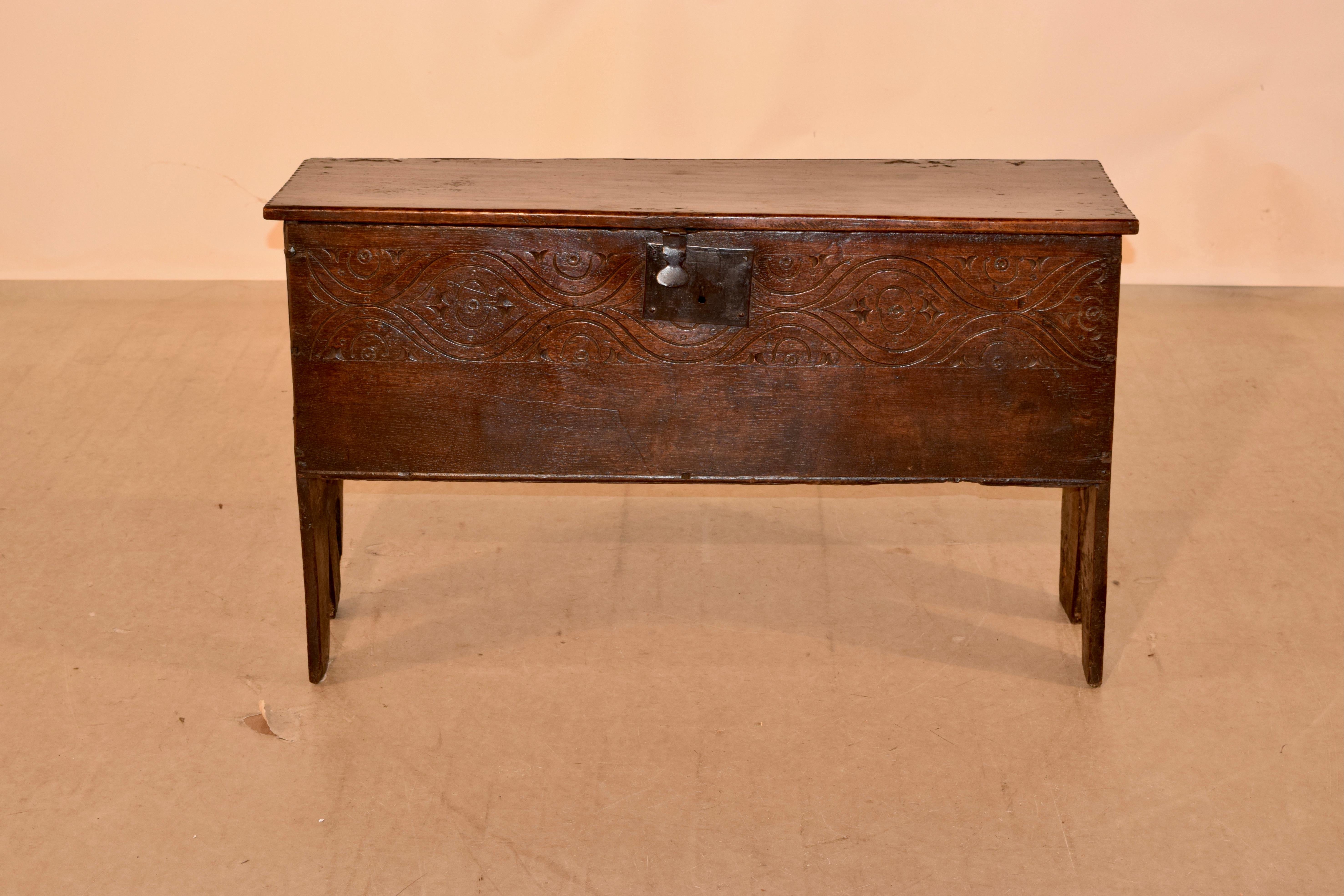 17th century oak period Charles ll sword chest from England made from six boards. The top has pie crust ends and opens to reveal storage. The front has hand carved decoration.