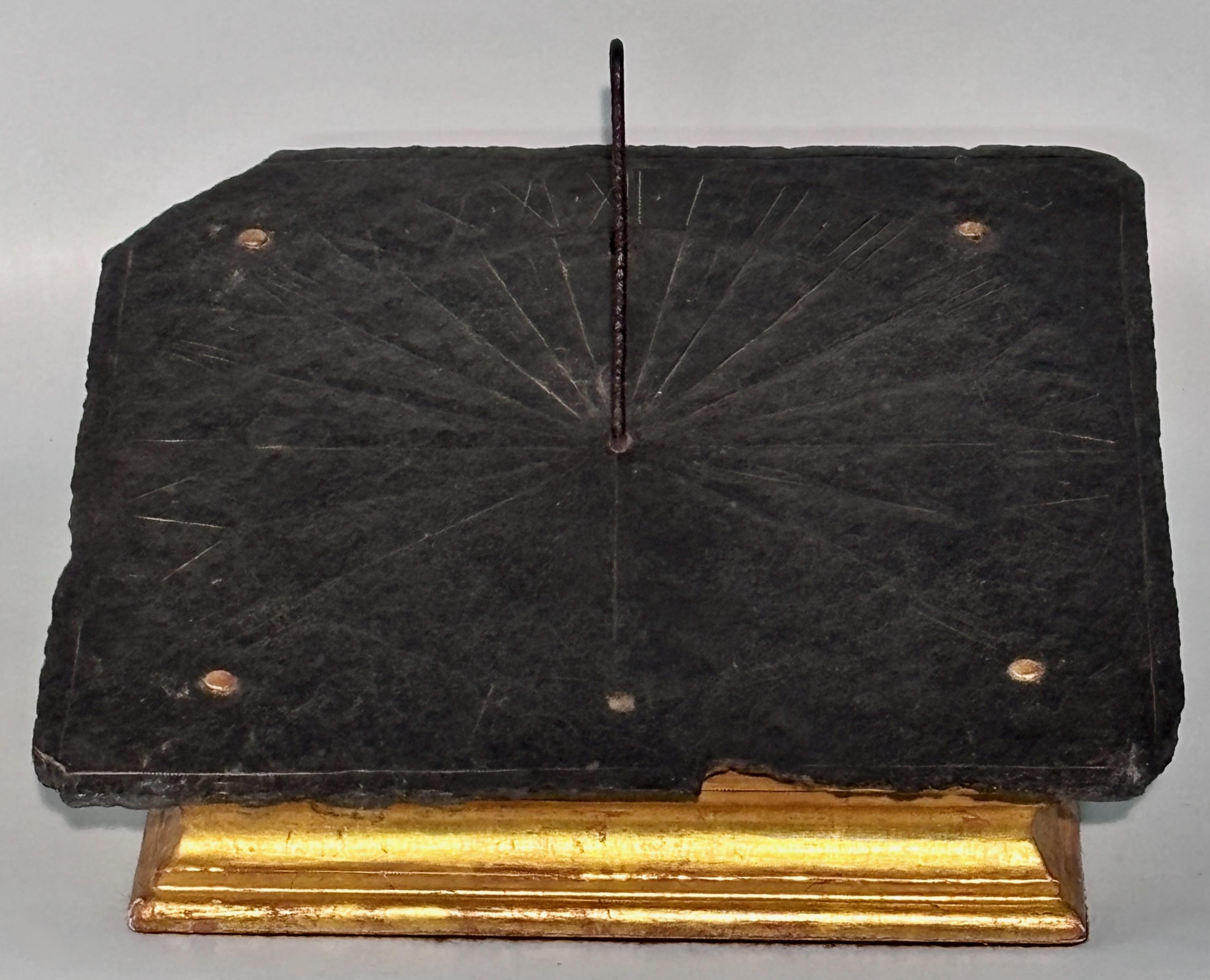 A very old slate sundial with iron gnomon on gilt wood stand.
Appears the date is 1654 (but this could be older as the date is hard to make out clearly). Has some old damage around the edges that is expected with a piece of this age.
Acquired from a