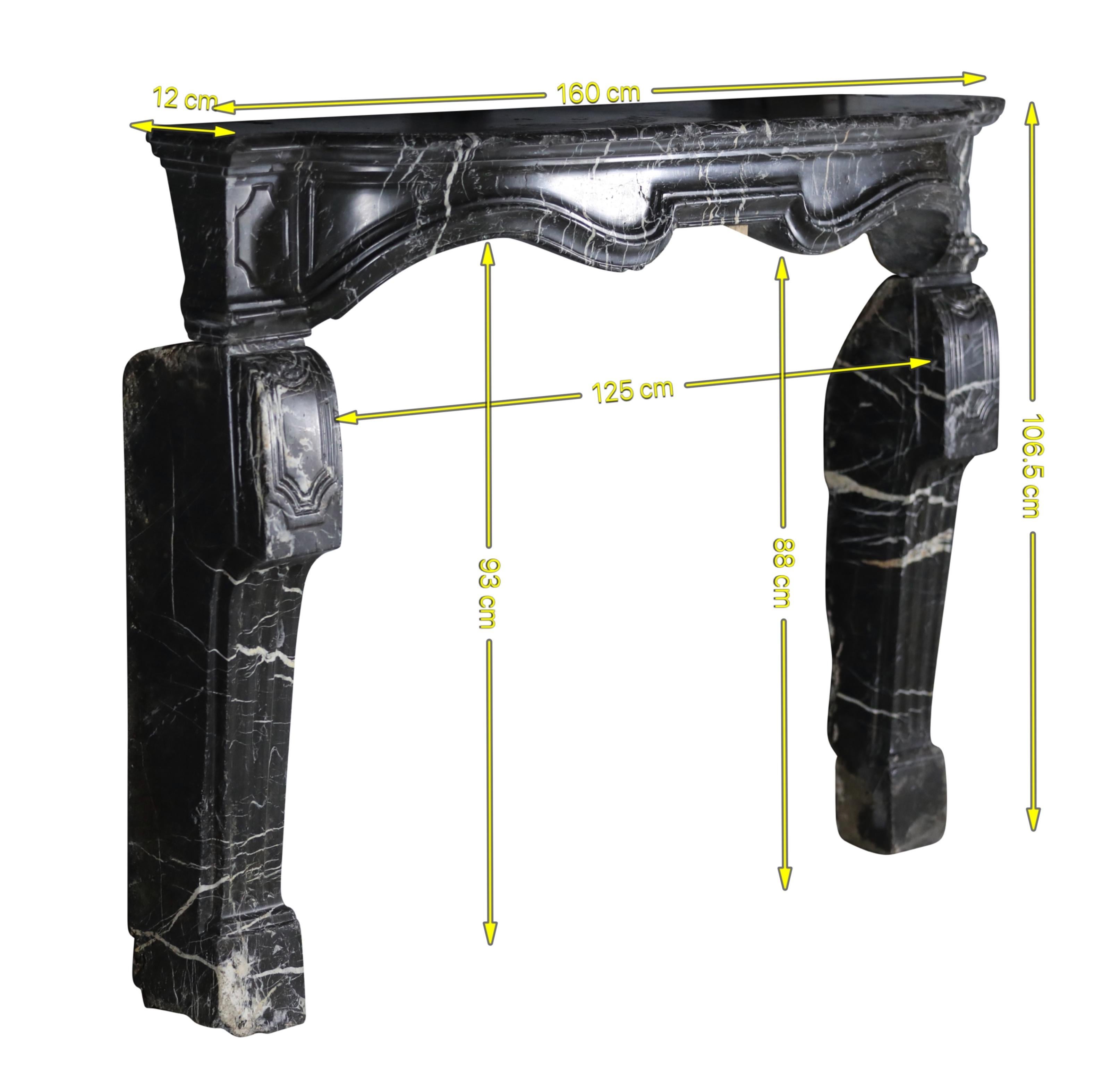 This exquisite perfect-imperfaction 17th-century fireplace surround is a testament to craftsmanship and history. Fashioned from luxurious black-grey marble with delicate white veining, its design possesses a graceful movement that captivates the
