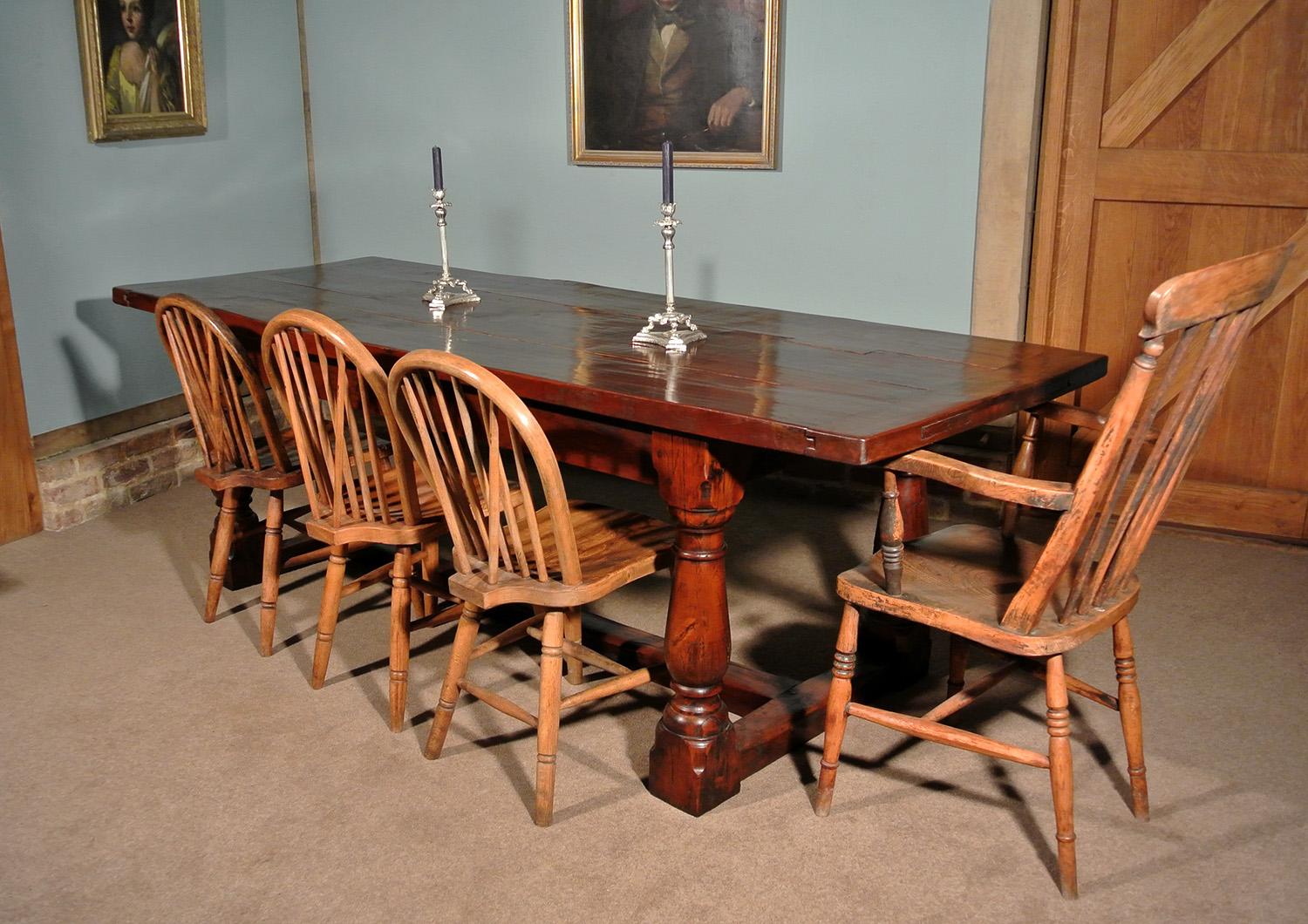 A beautiful 17th century refectory table made from substantial yew wood timbers and with attractive top of four varying width boards with some slight shrinkage and undulations, with cleated ends and set on four large baluster turned legs united by a