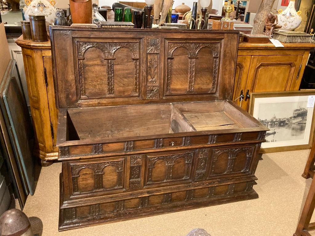 Superb 17th century Spanish Baroque wedding cassone, the walnut surface hand carved with architectural designs, arches, geometric and floral motifs throughout, including on the inside of the lid. One front panel opens to reveal three drawers.