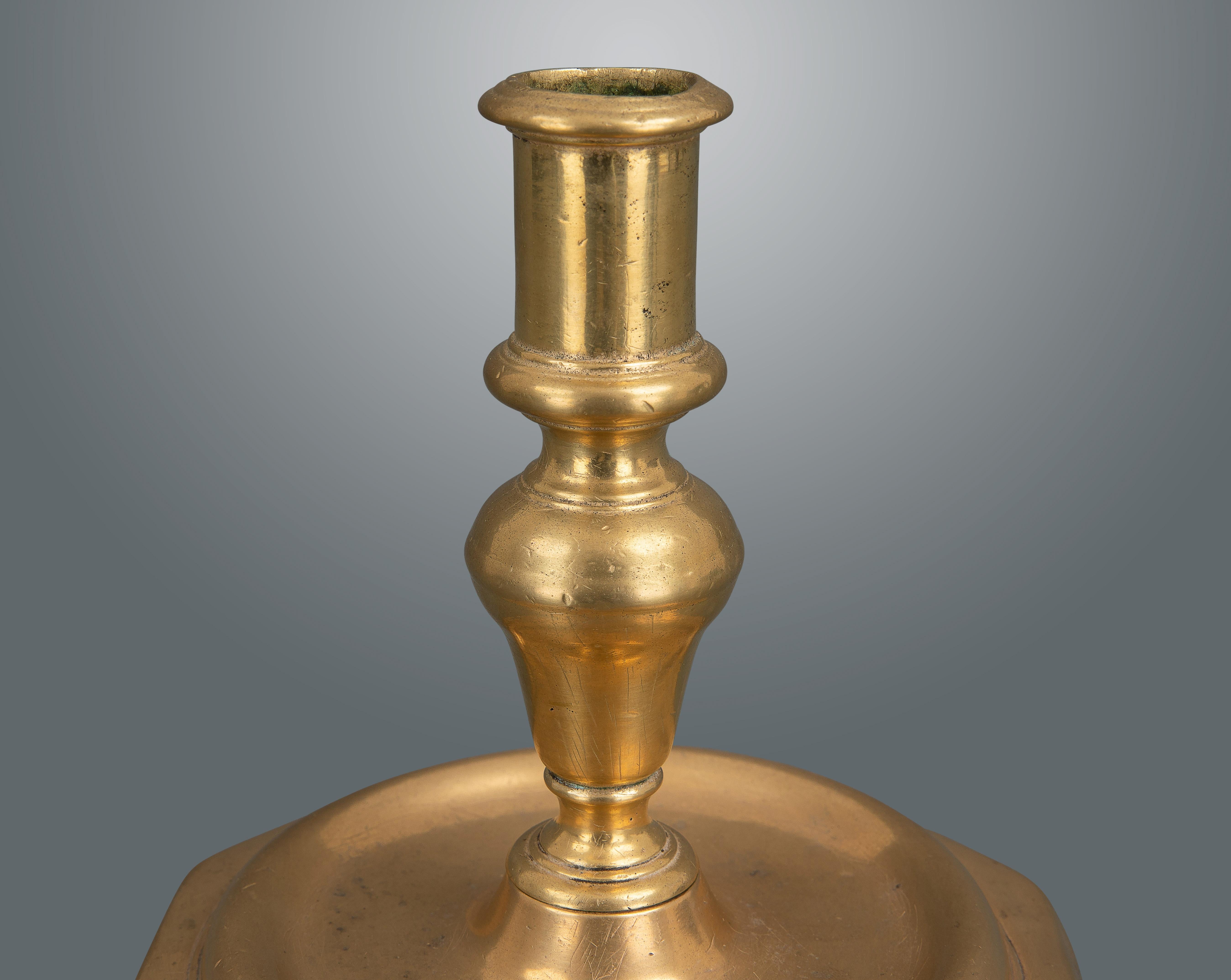A very nice example in rose colored brass. Heavily cast in two pieces with a screw fitting and six sided base.