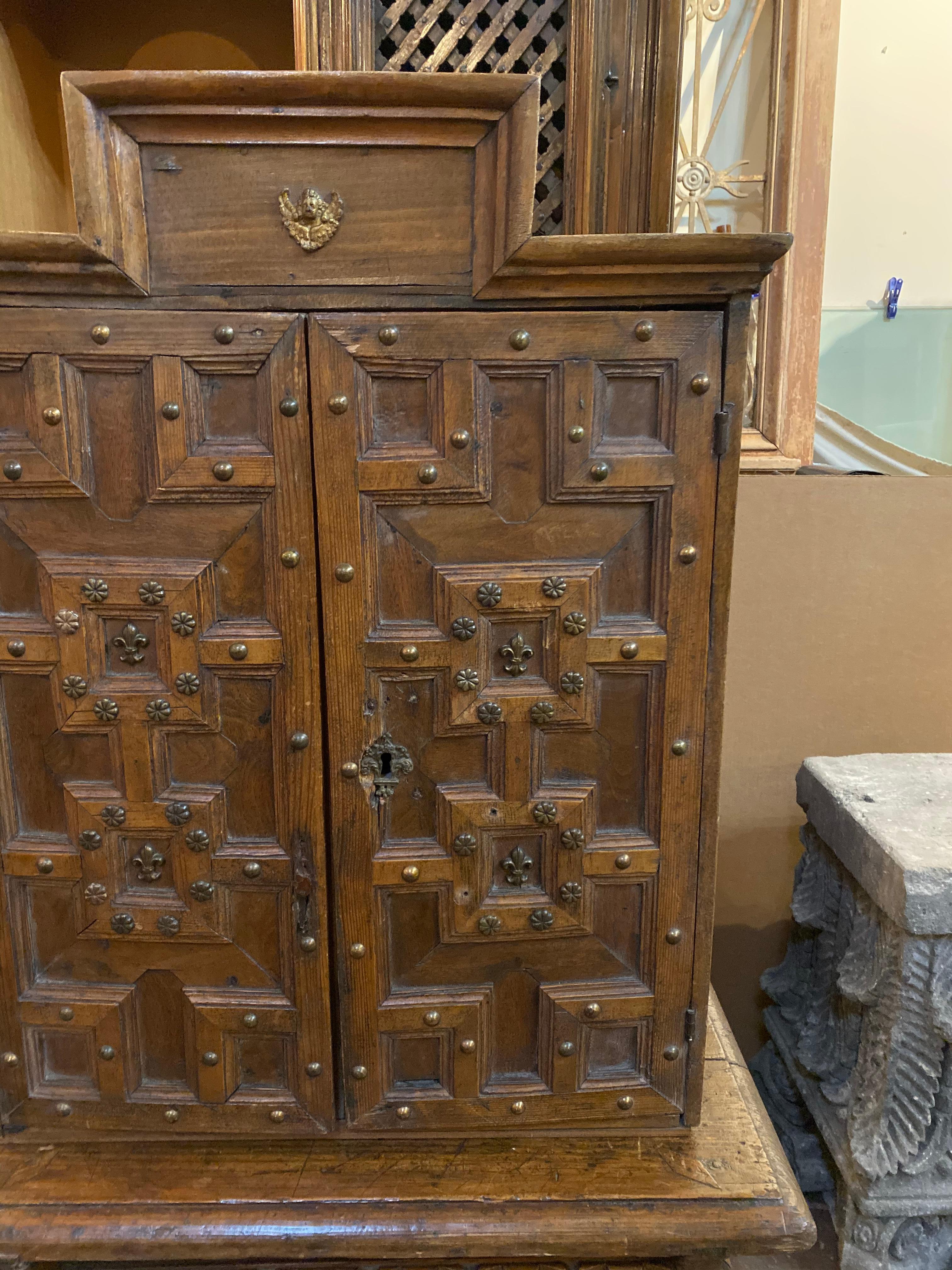 This beautifully carved and well preserved cabinet was likely used in a church. It originates from Spain circa 1680. 

Measurements: 17