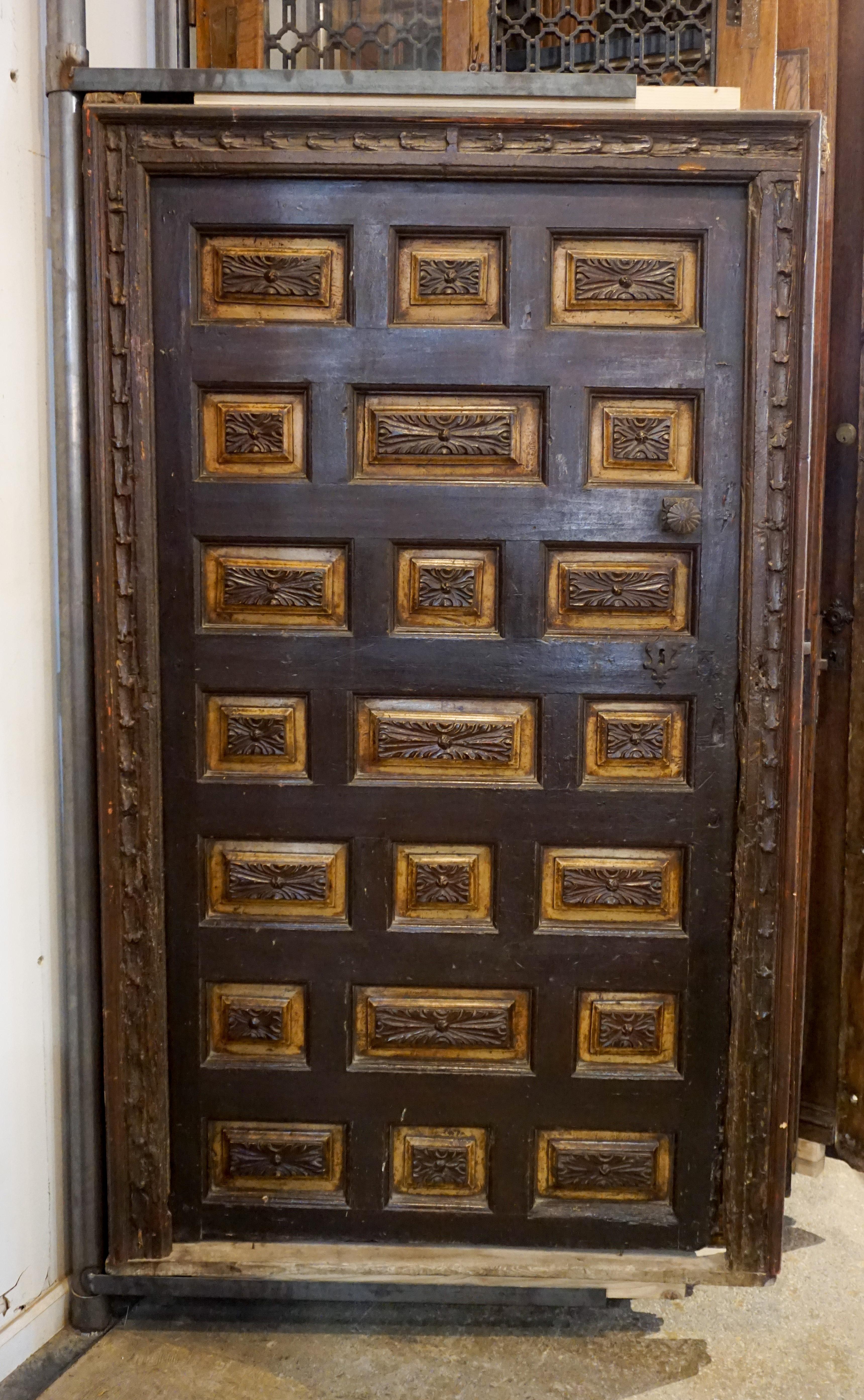 Spanish single door adorned with carved decorative inset panels as well as a carved frame. 

Origin: Spain, circa 17th Century

Measurements: 78 1/2