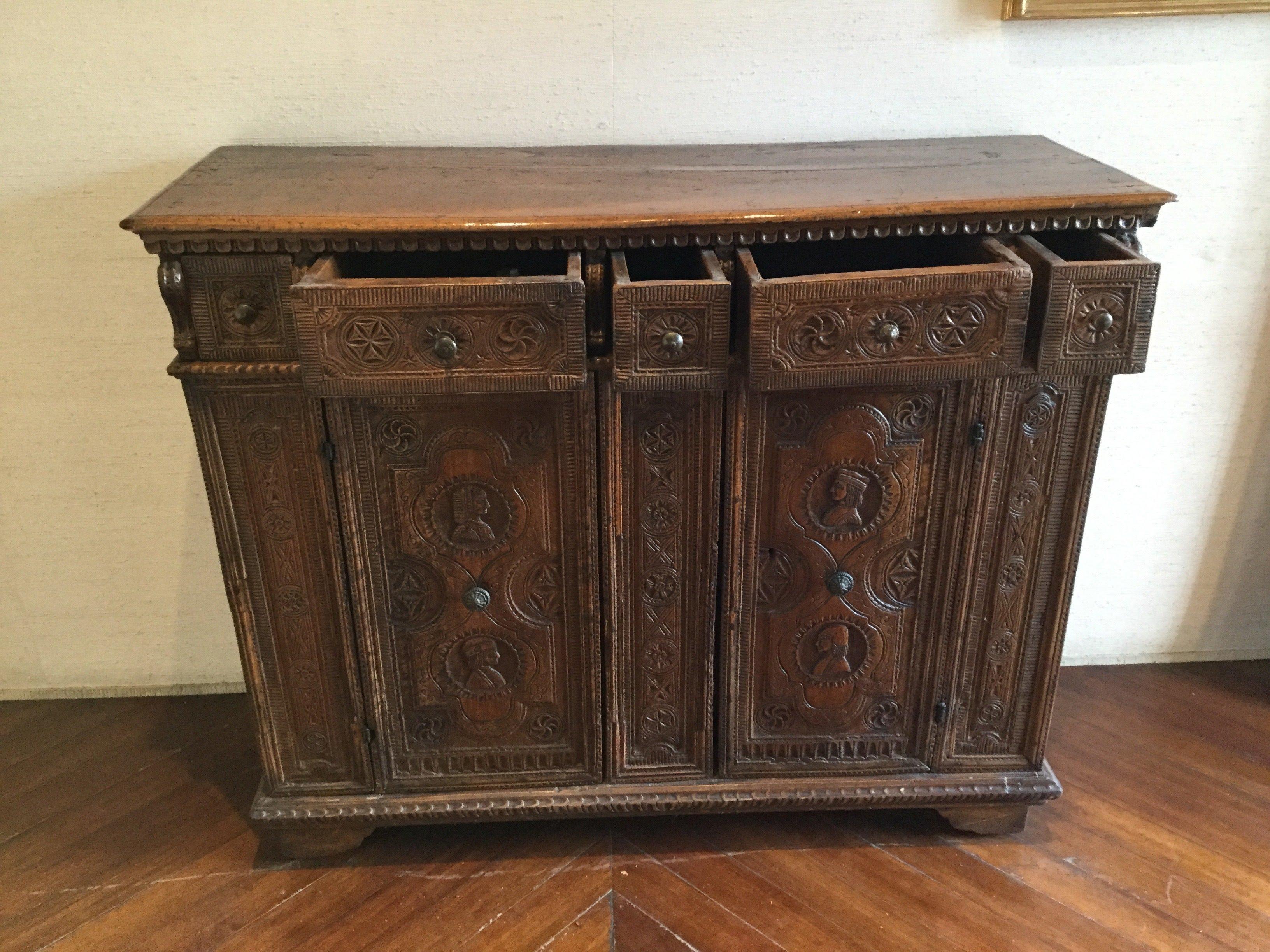 An impressive hand-carved Spanish Walnut Credenza. The doors are crusted with carved medallions of a lady and a gentleman on each of them linked by a rosette. Rectangular top with moulding.
Five-drawer (two small lateral, one small central and two