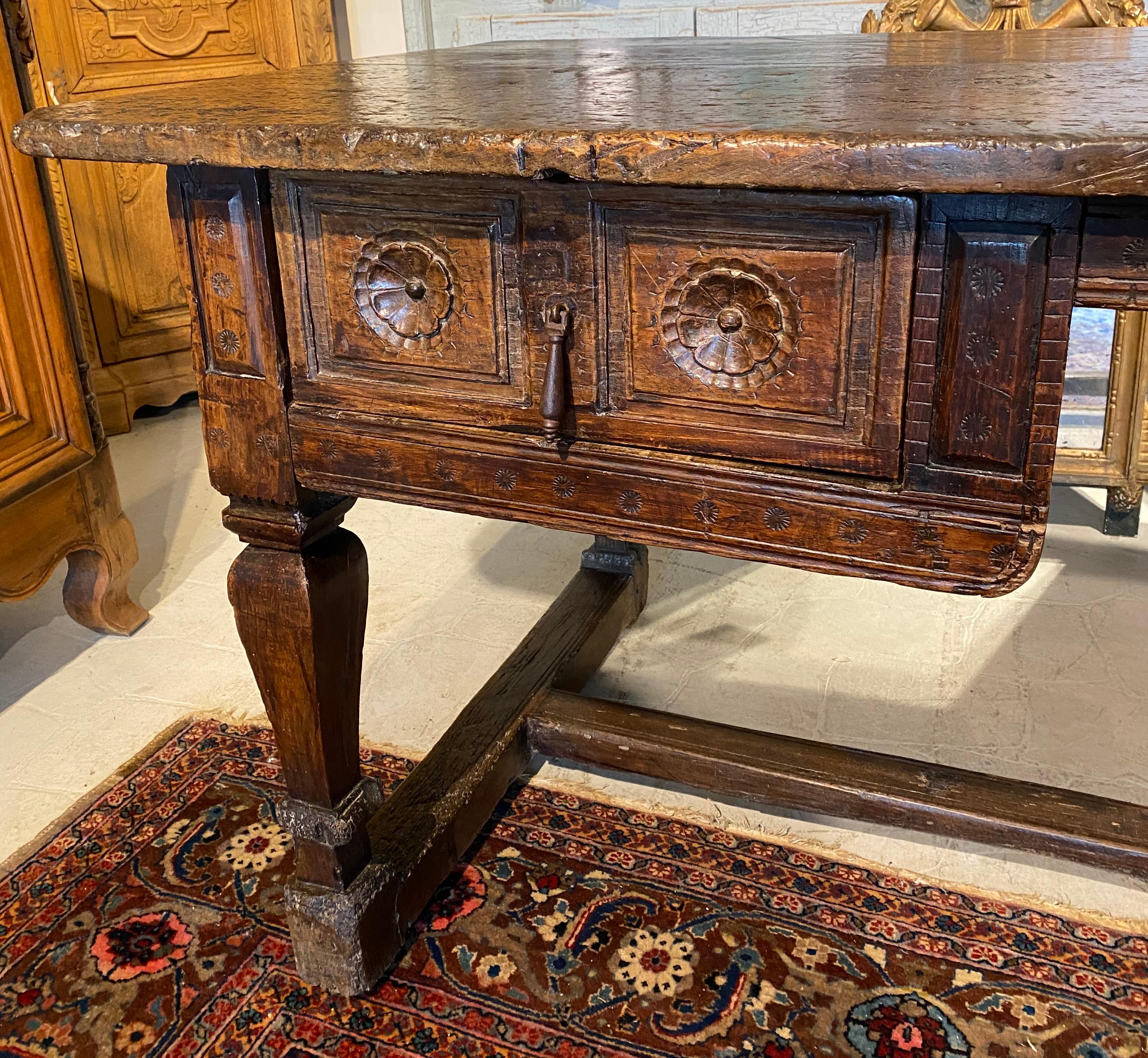 Spanish colonial desk 17th century, in walnut,the patina on the top is exceptional .
only 400 years of use can give such rough beauty.
This is a very spectacular piece of furniture the carving is present on the drawer but not toon much a lot of