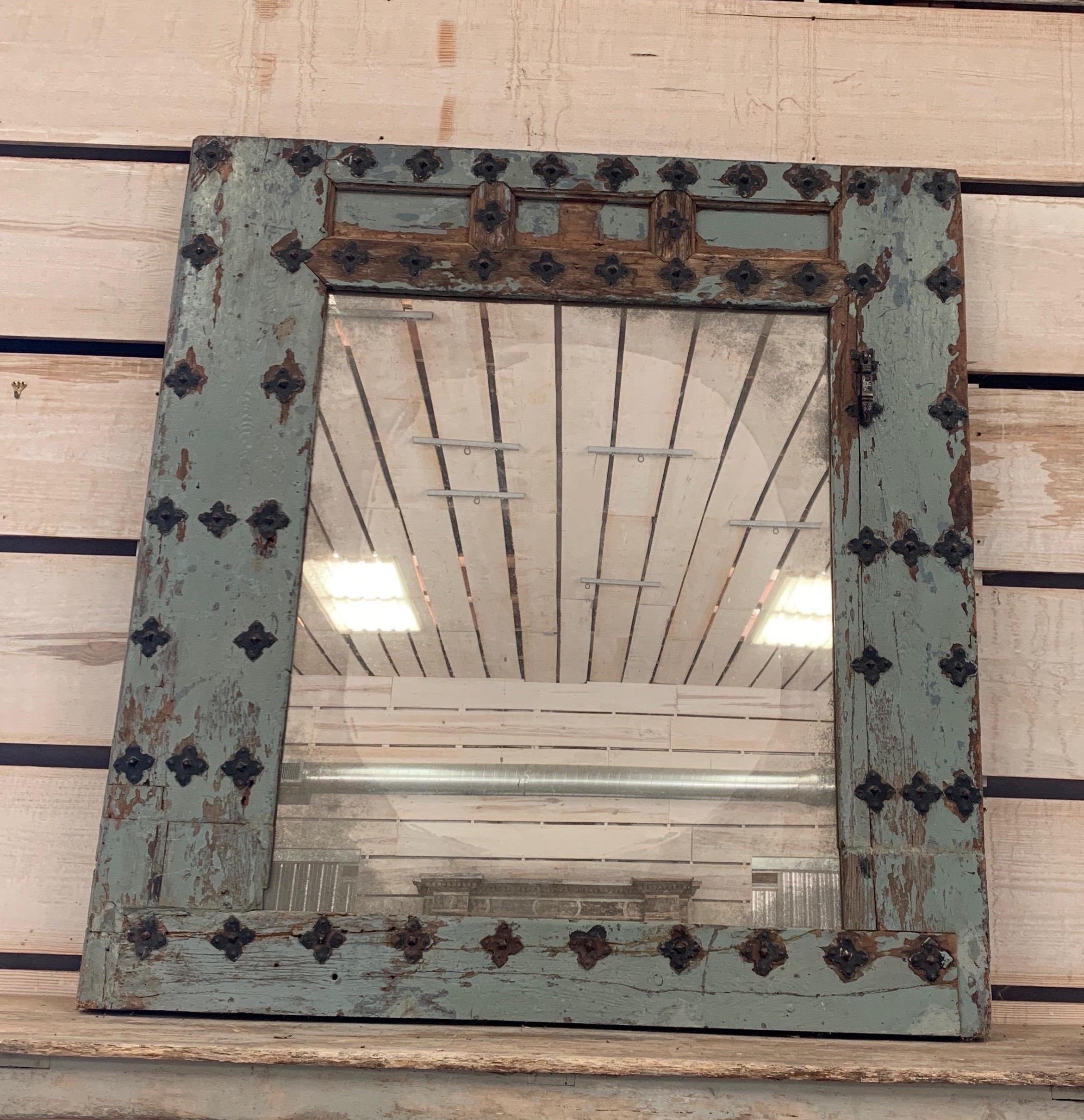 This Spanish mirror from far southern Spain has incredible hardware and painted patina. The mirror was added later and aged to fit this early door frame as it was originally.