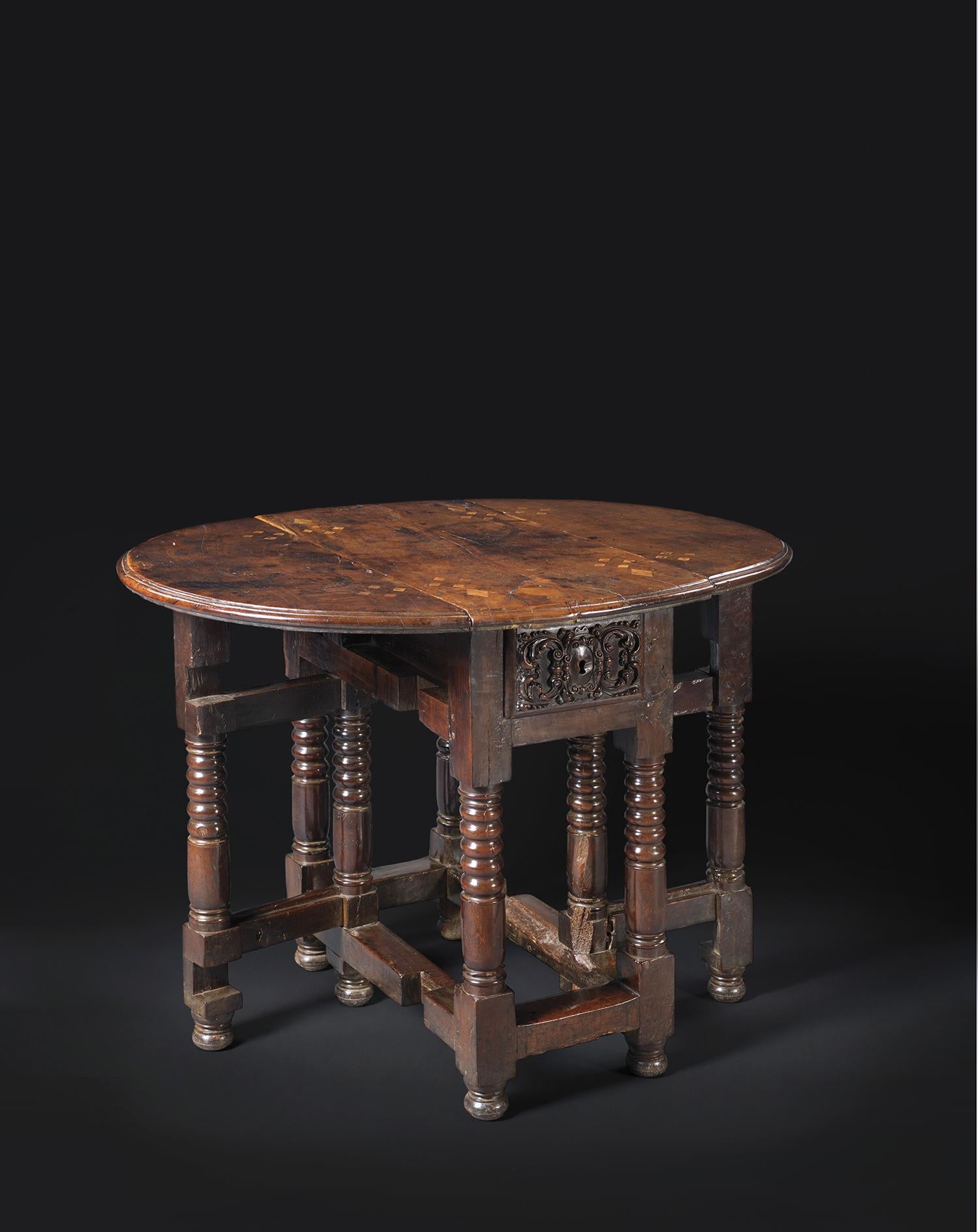 Measures: height : 80 cm
Length : 83 cm
Full length : 108 cm
Depth : 40 cm

Walnut inlaid with ligh coloured wood 

This original and clever walnut table stands on rotating feet. Four turned-wood legs, linked by a circular spacer, support the