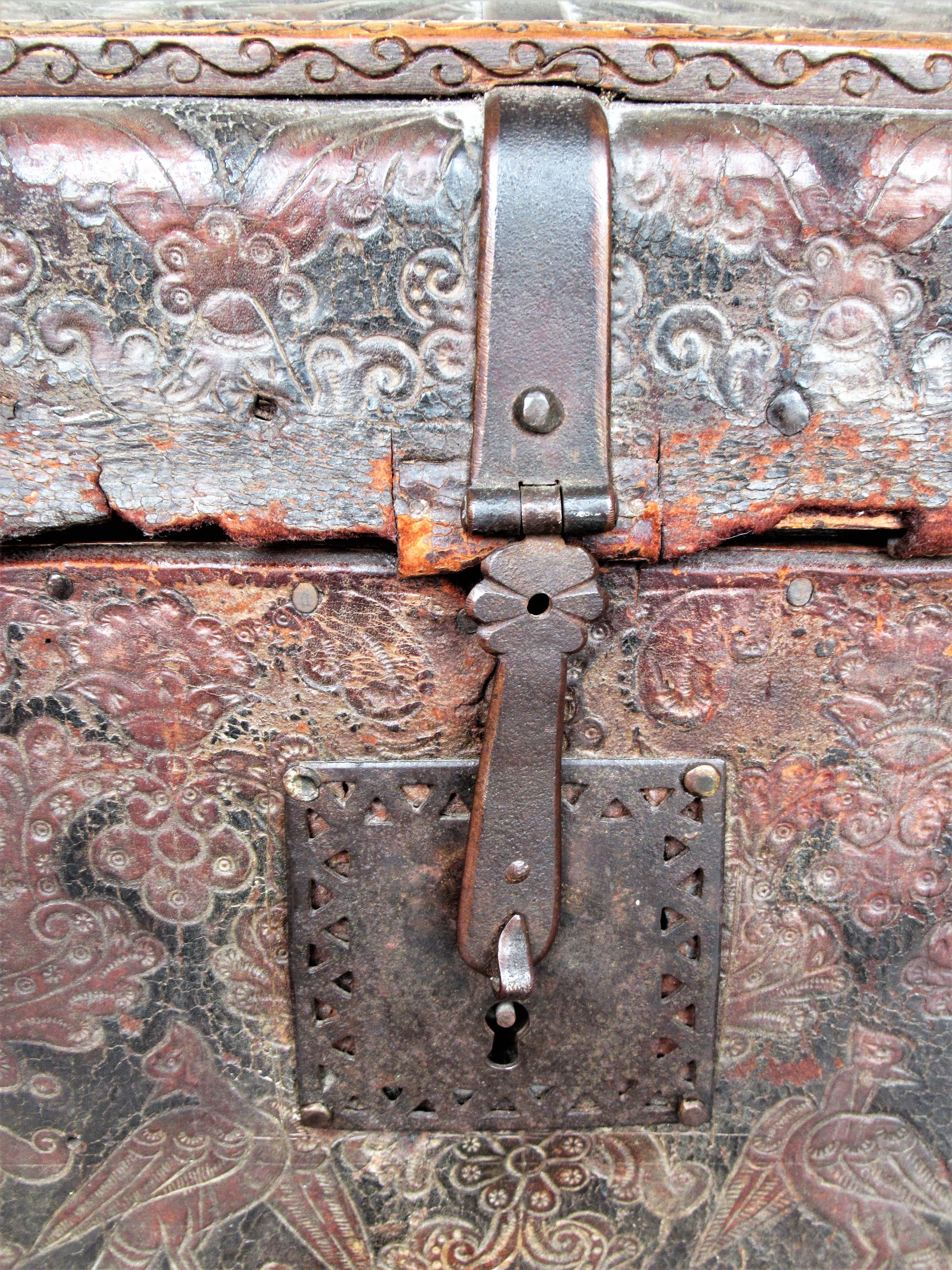 Antique Spanish hand tooled leather covered wood trunk w/ period hand wrought iron hardware, locks, handles, escutcheons. Beautifully aged original surface w/ finely detailed decorations - eagle birds, shields, heraldic symbols. Late 17th century -