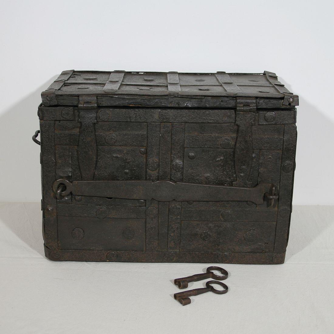 Beautiful and rare strongbox from Spain with a very great size. Made out of wrought iron on wood with two working locks. In front of these locks there is an extra wrought iron cover placed that could also be locked with a padlock. This piece shall