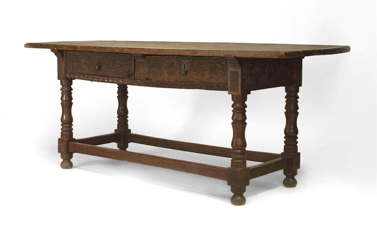 Spanish 17th century oak refectory table with 2 carved drawers & apron supported on turned legs with stretcher at base.
 