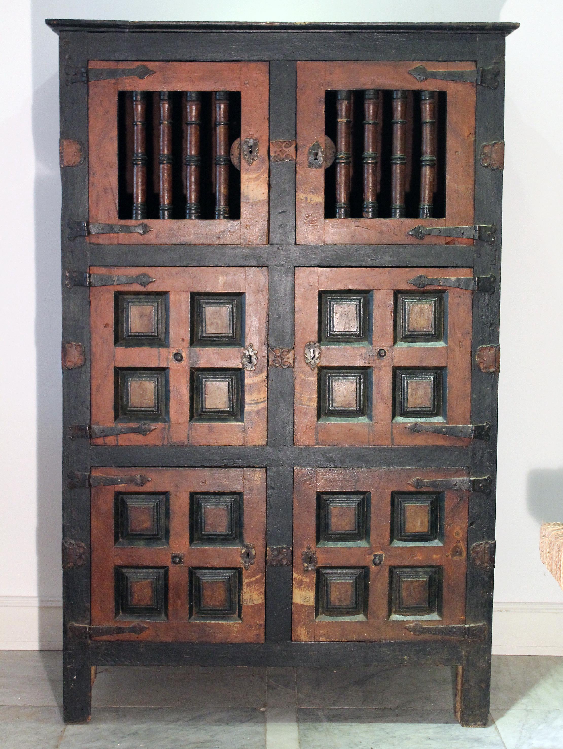 17th century Spanish cabinet with original doors, locks and fittings. Composed of hand painted coffered side panels and front doors, where the top two are use bars instead. This type of cabinets were hand made in Valladolid, 300 km north of