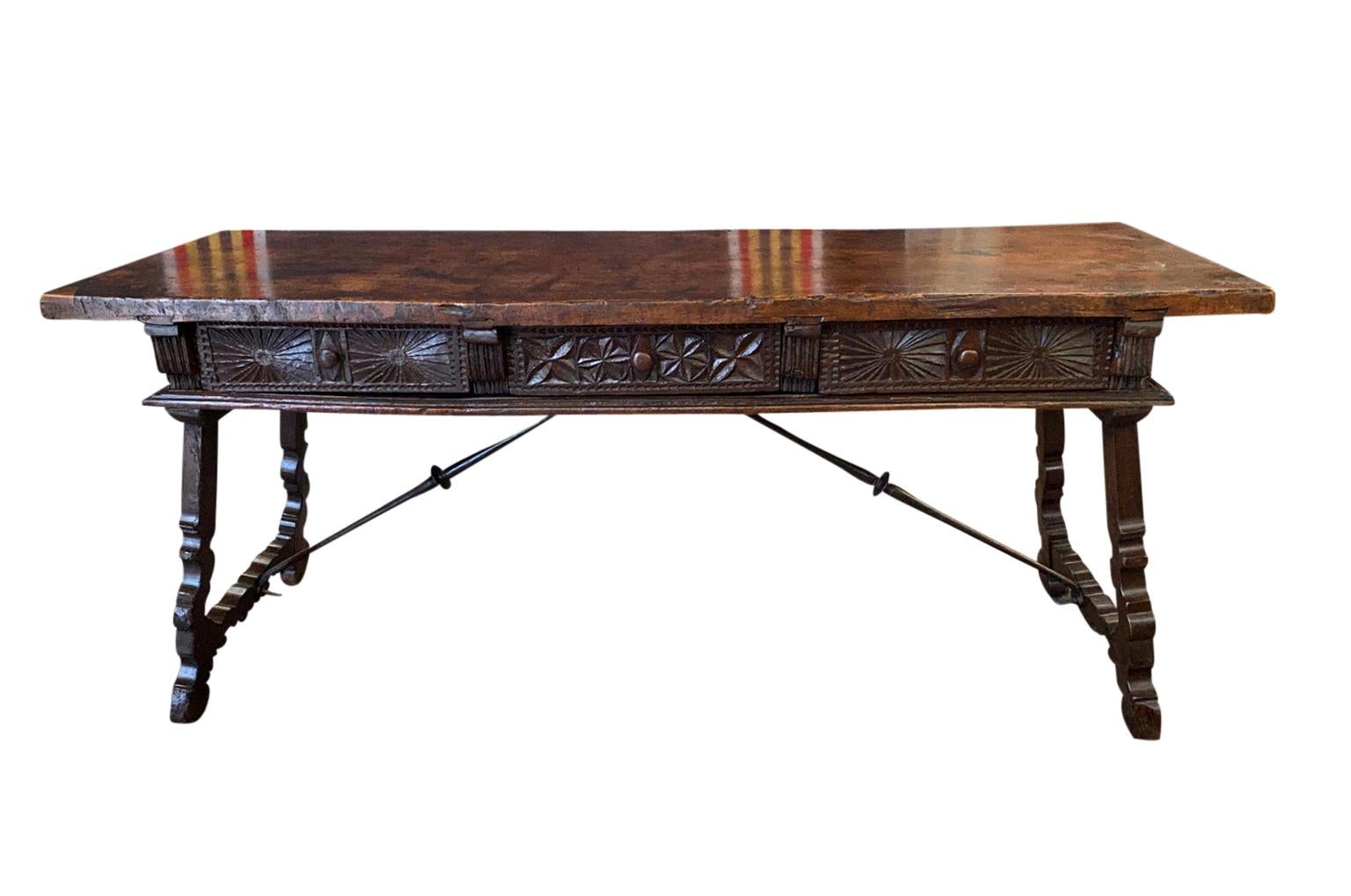 An outstanding 17th century Spanish Reflectoire Table - Writing Desk beautifully constructed from handsome walnut in the Renaissance taste.  Tremendous solid board top, carved drawer fascias, lyre shaped legs and hand forged iron stretchers.  A very