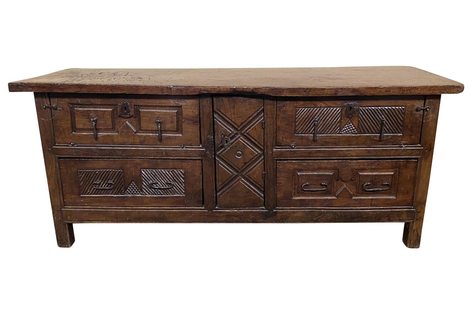 A truly exceptional 17th century sacristy commode, buffet from Spain. Beautifully constructed from stunning walnut and oak with a solid board top, two drawers and three doors. Sensational patina. This piece will be the statement of its surrounding.