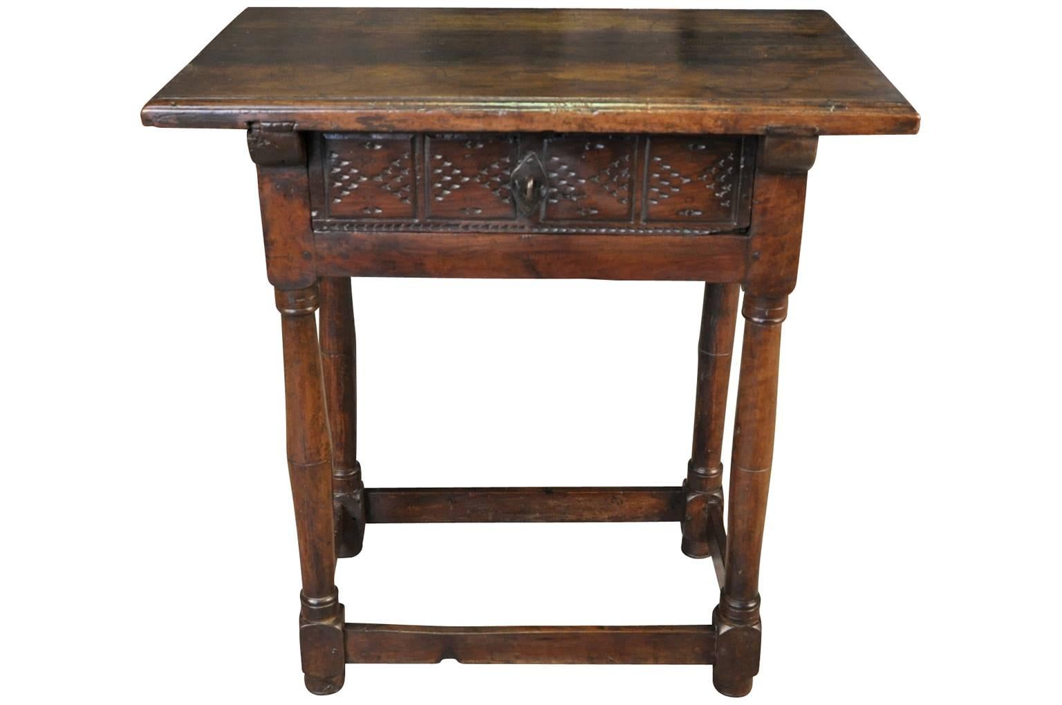 A very handsome 17th century side table from Valencia, Spain. Beautifully constructed from stunning walnut with a single draw with a carved fascia and very interesting turned legs. Wonderful patina, rich and luminous.