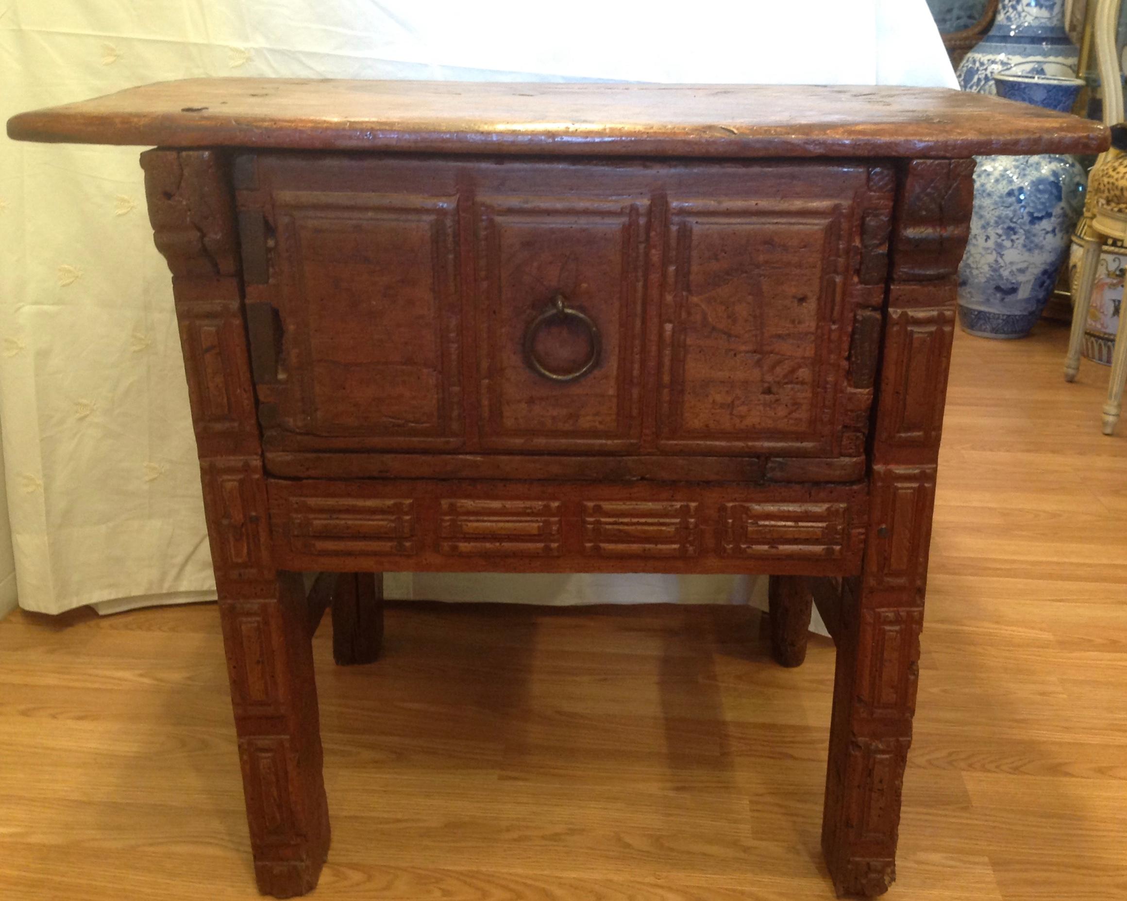 Carved from hardwood with wonderful patina. The piece displays outstanding 
and prominent exposed dovetailing. It is fitted with a massive central drawer.