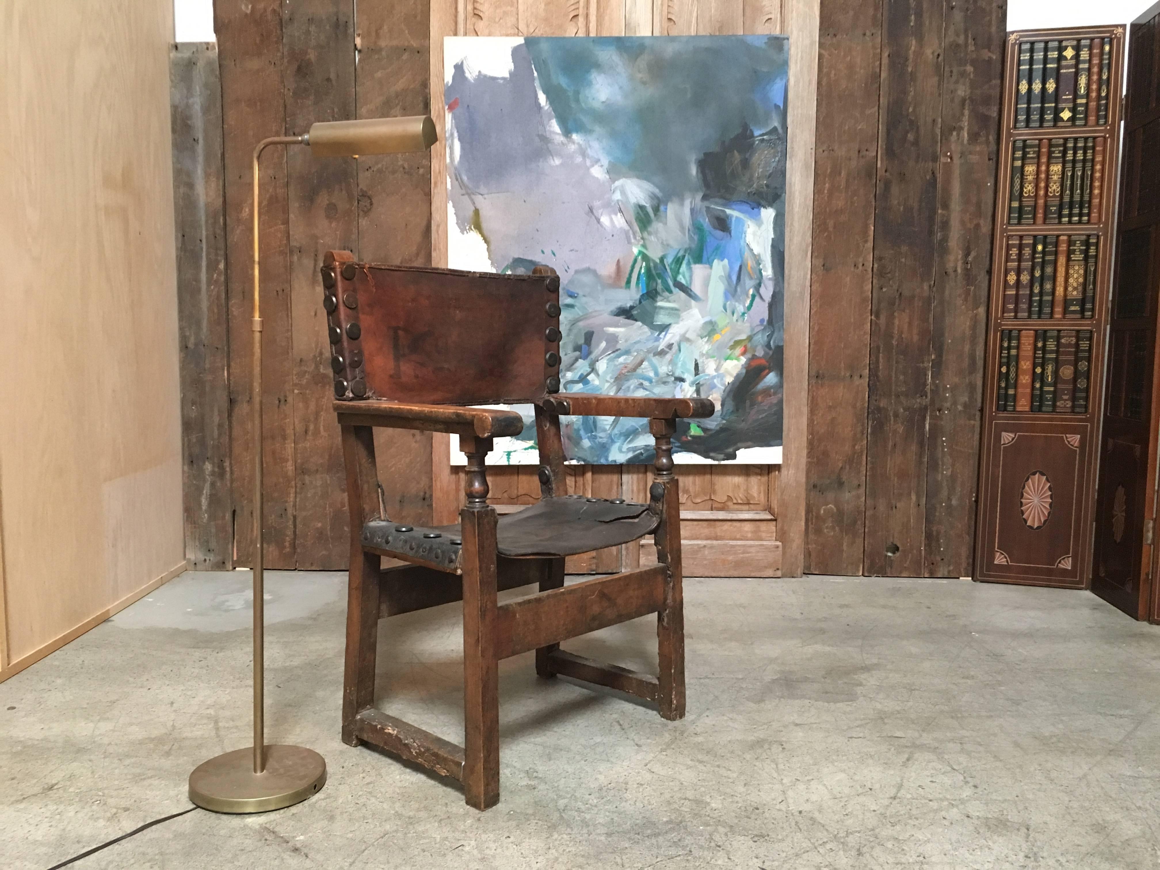 This chair has wonderful distressed patina of the leather and the wood perfect for a Tuscan, French or Spanish style home.