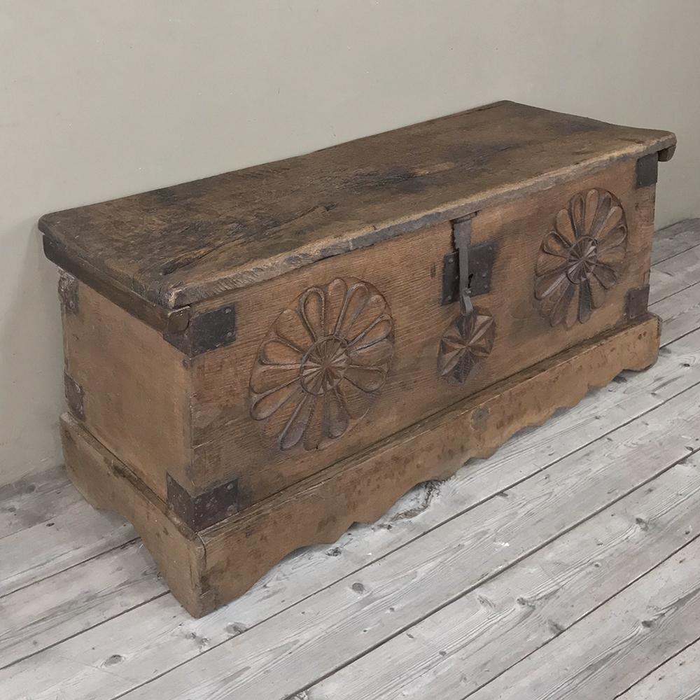 17th century Spanish trunk has served its masters for generations, and is now ready to serve a new master! Handcrafted from solid oak and fitted with forged iron lockwork, it was carved with rustic motifs for a little flair. Ideal at the foot of the