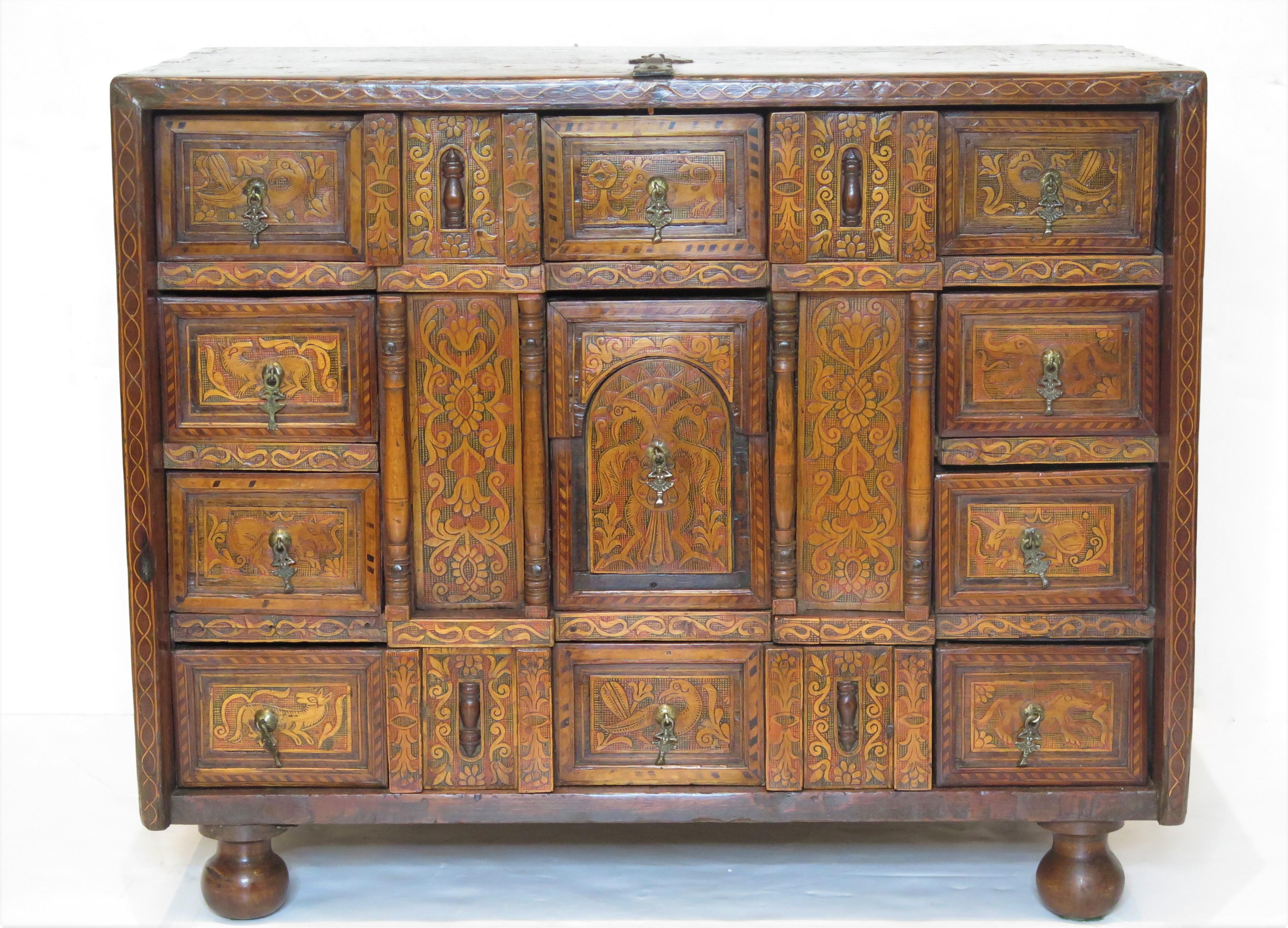 a 17th century Spanish vargueño / traveling cabinet with intricately inlaid top, sides, and small drawers, fruitwood, Italy, 17th century